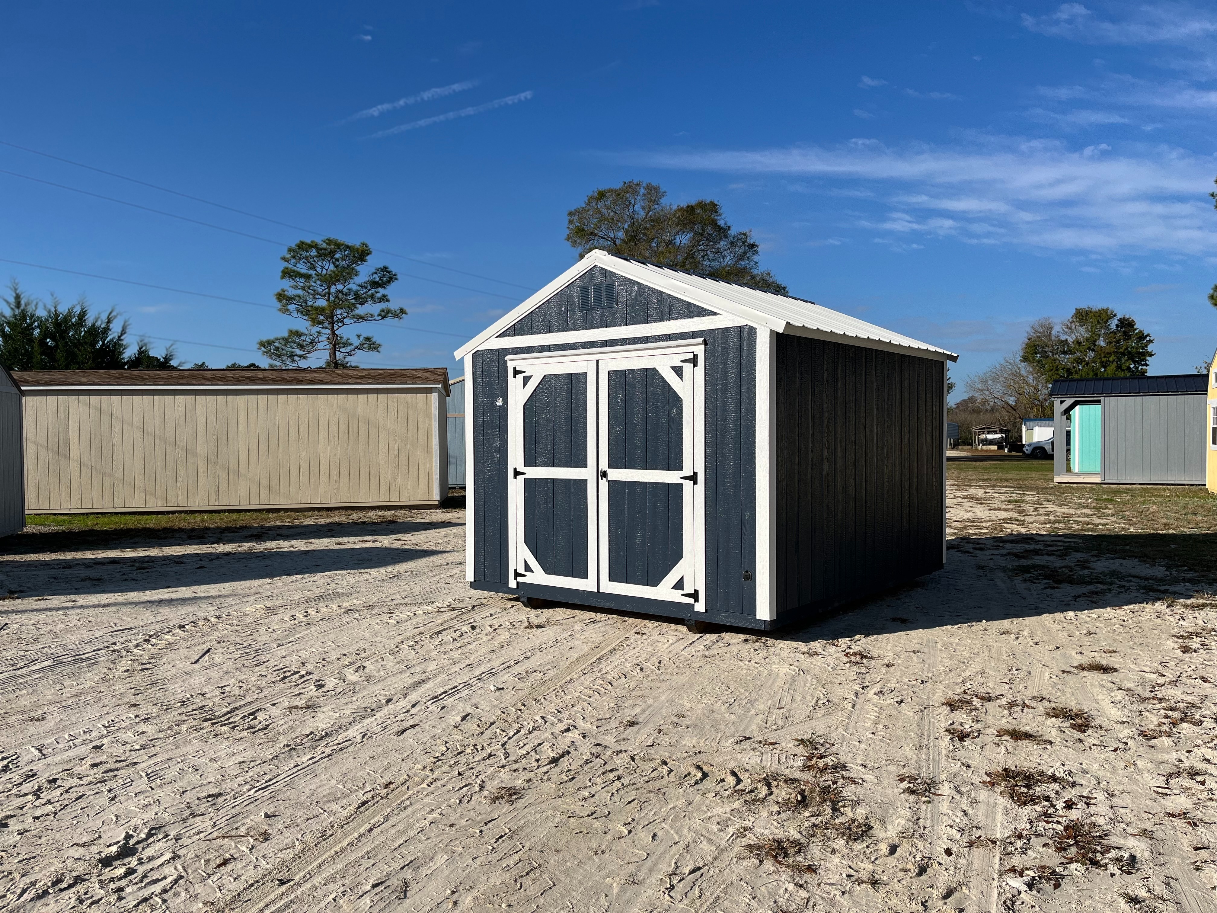 Exterior front and right side view of a blue 10x12 garden shed economy with double wood doors