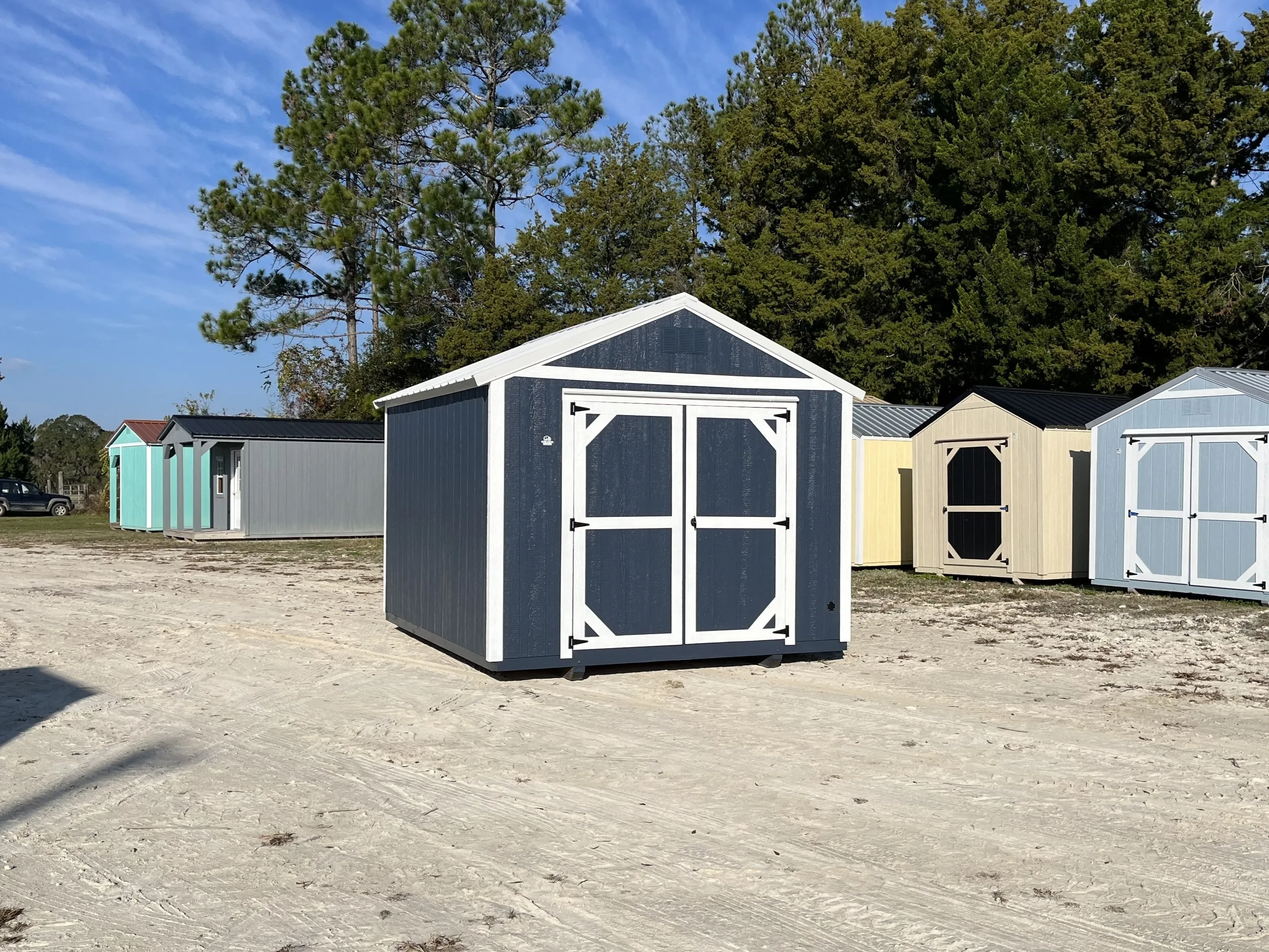 Exterior front and left side view of a blue 10x12 garden shed economy with double wood doors