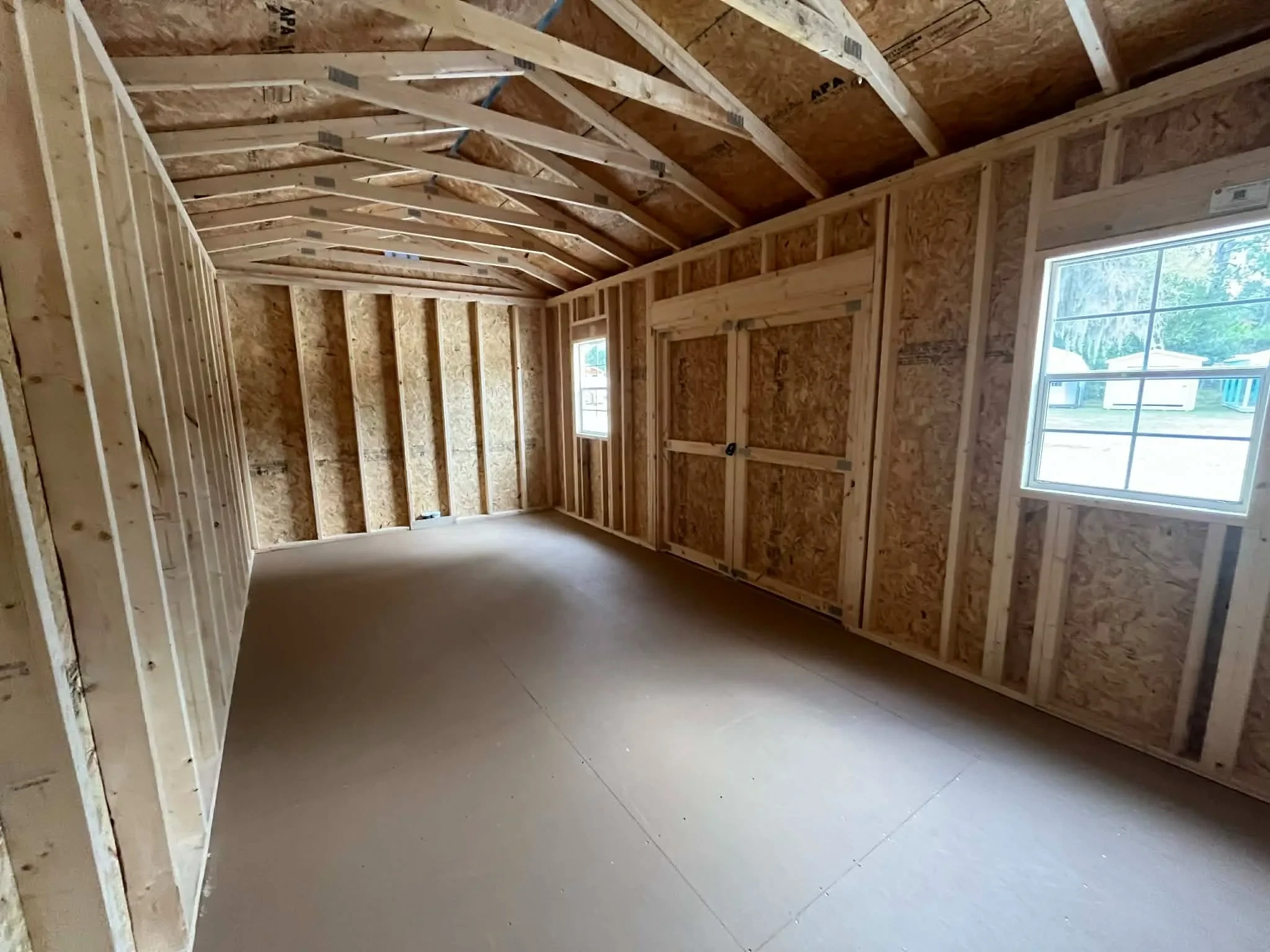 Interior view of a 10x20 side garden shed showing doors and windows
