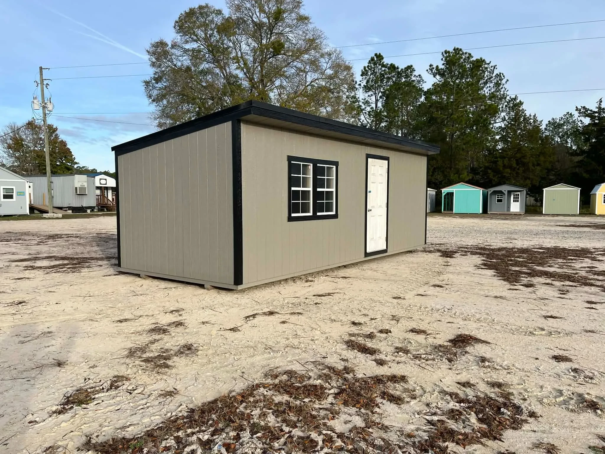 Exterior of a 10x24 clay in color Urban showing the walk-in door and windows