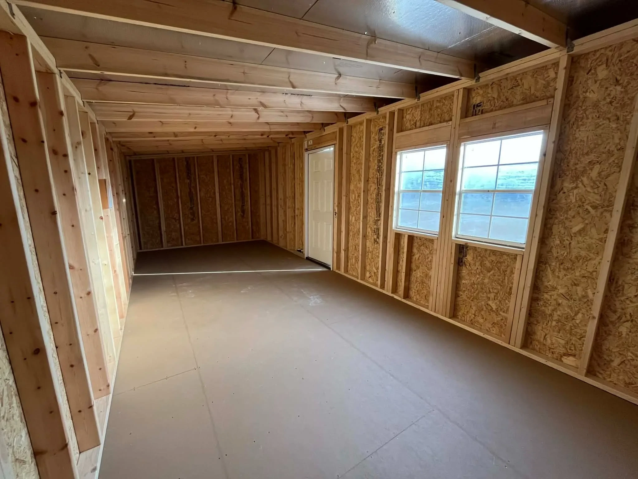 Interior view of a 10x24 urban showing a walk-in door and windows