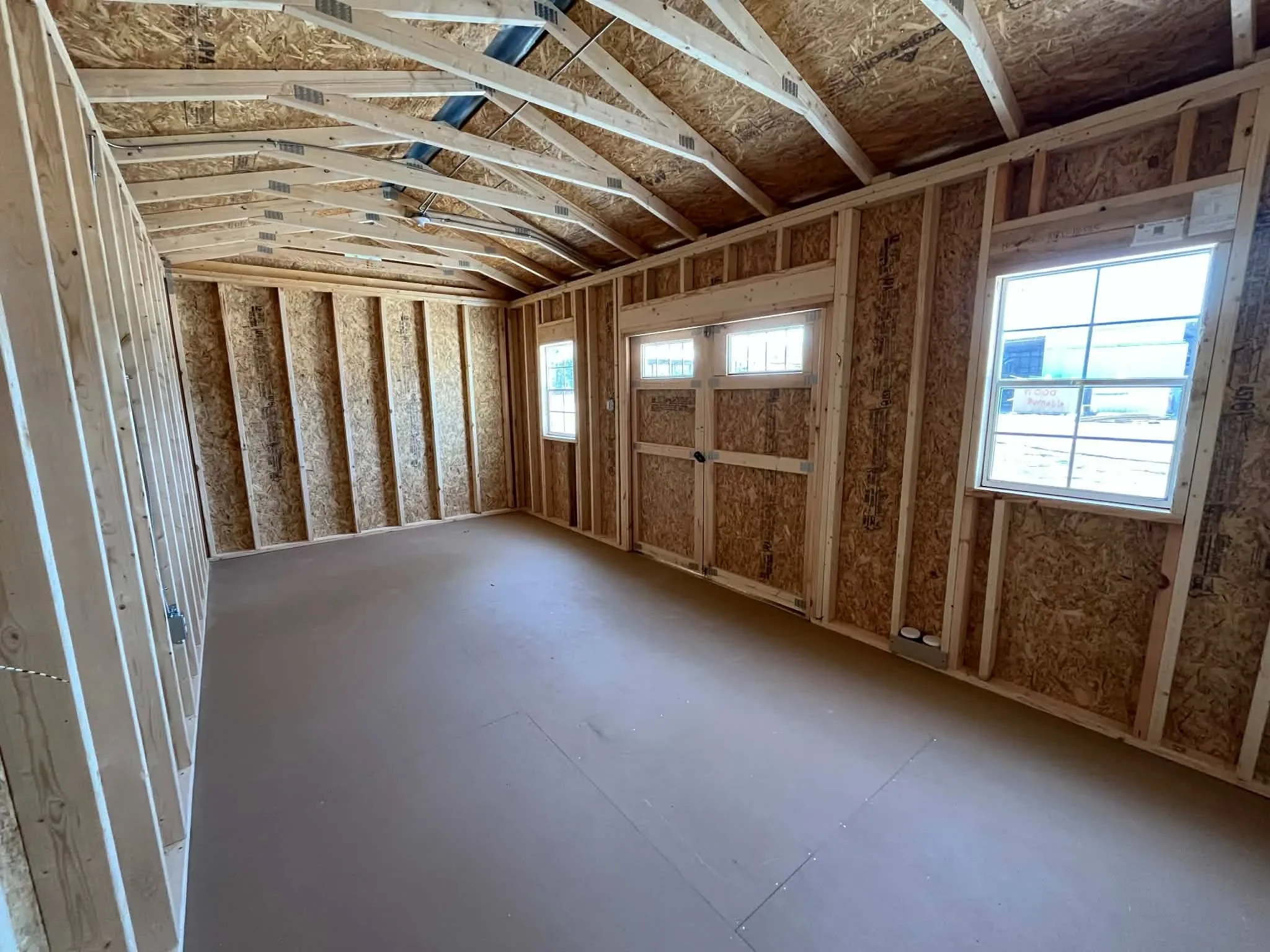 Interior view of a 10x20 side garden shed showing doors and windows