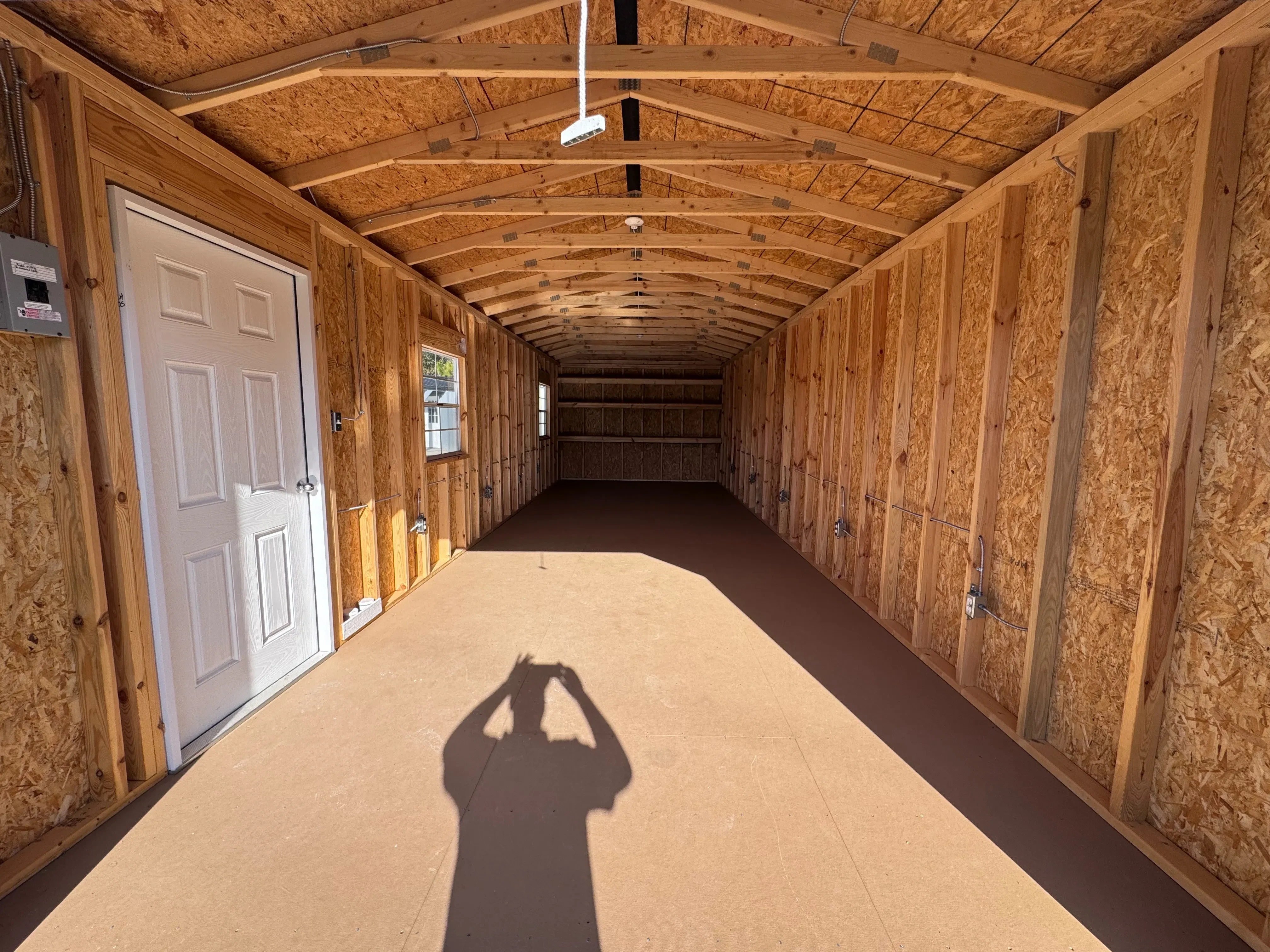 60 amp subpanel inside workshop next to entry door with visible electrical outlets