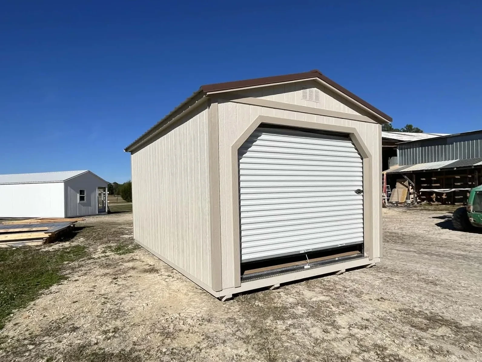 Exterior of a 12x16 workshop with a roll up door