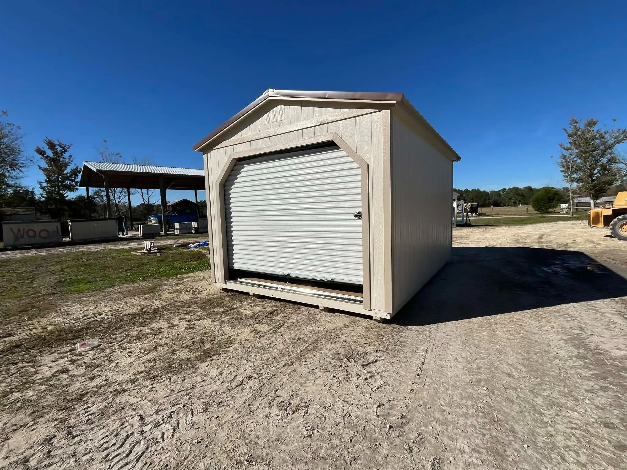 Exterior of a 12x16 workshop with a roll up door