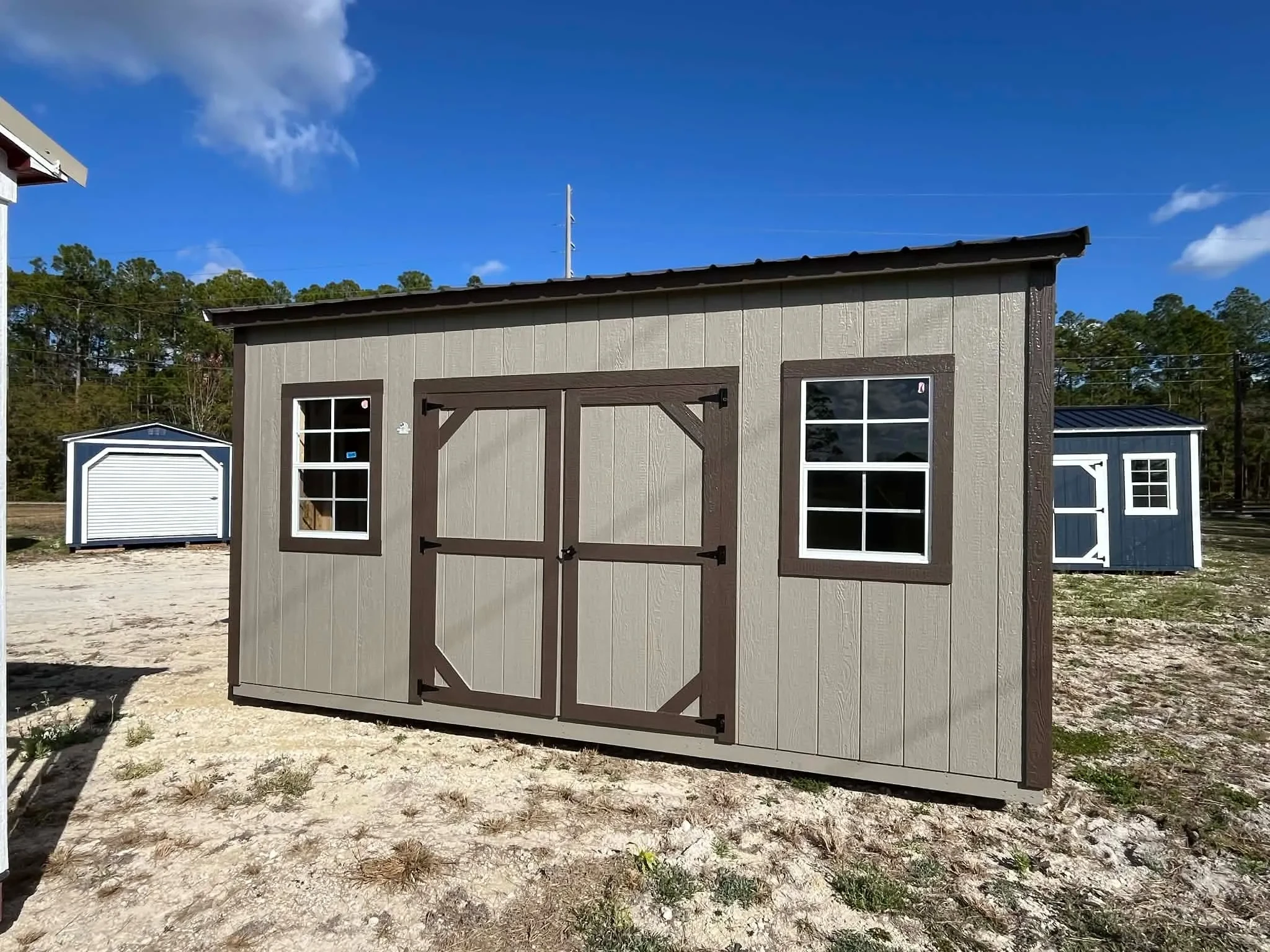 Exterior of a clay in color 10x16 side garden shed showing doors and windows
