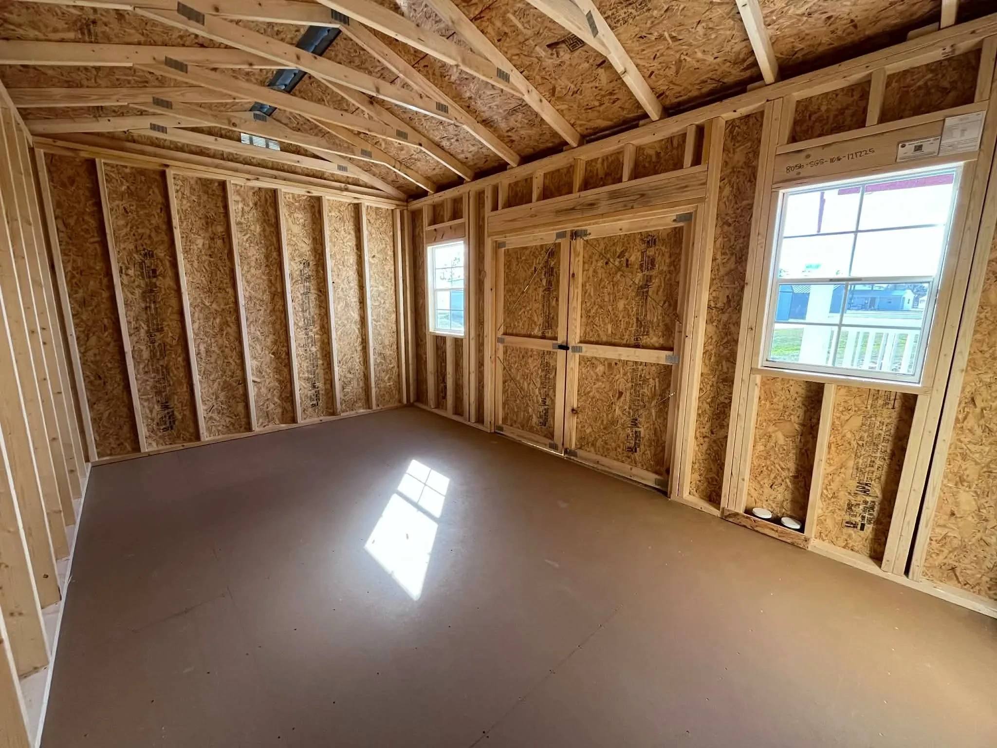 Interior of a 10x16 side garden shed showing doors and windows