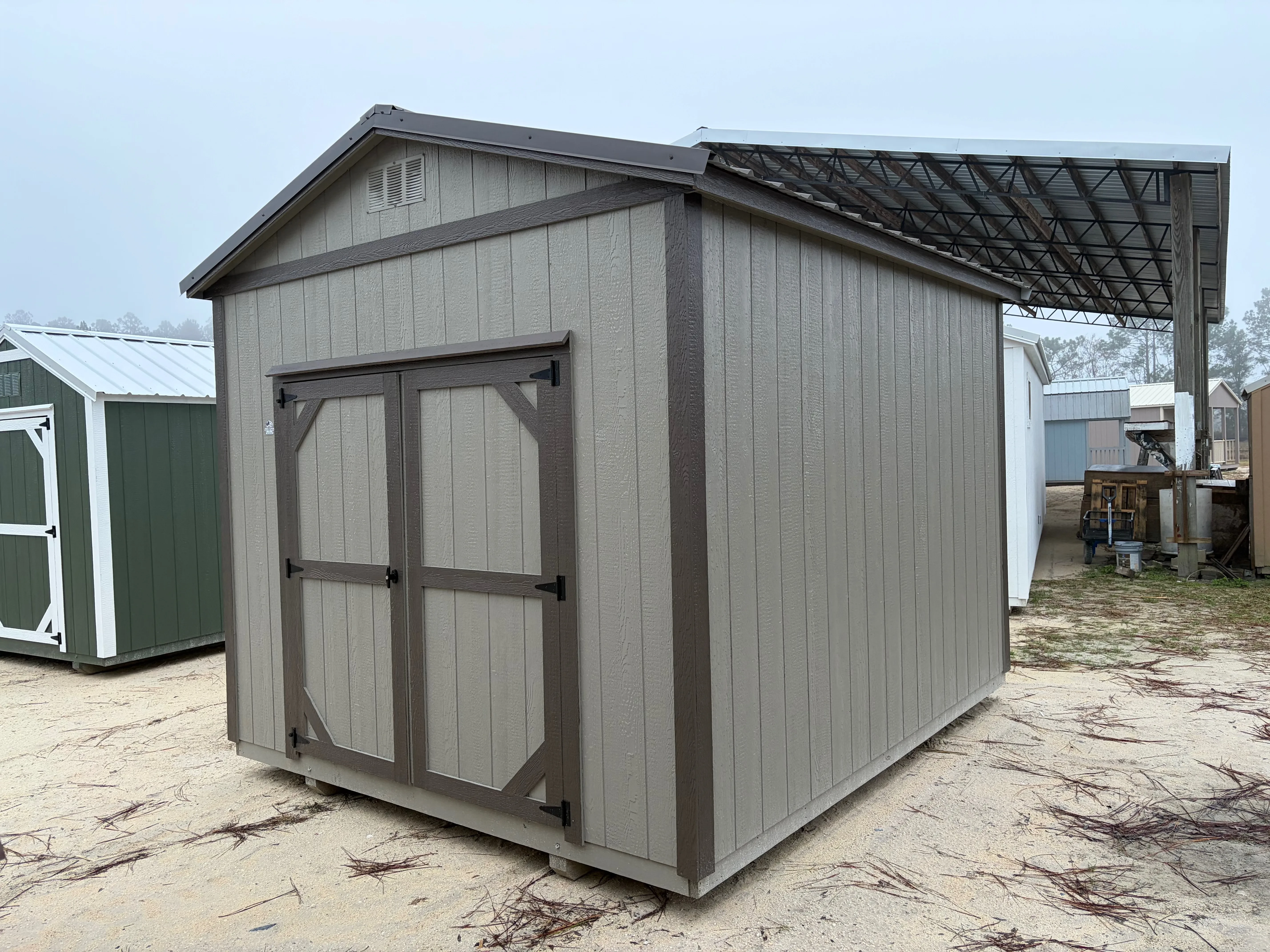 Exterior of a clay colored garden shed with a double wood door