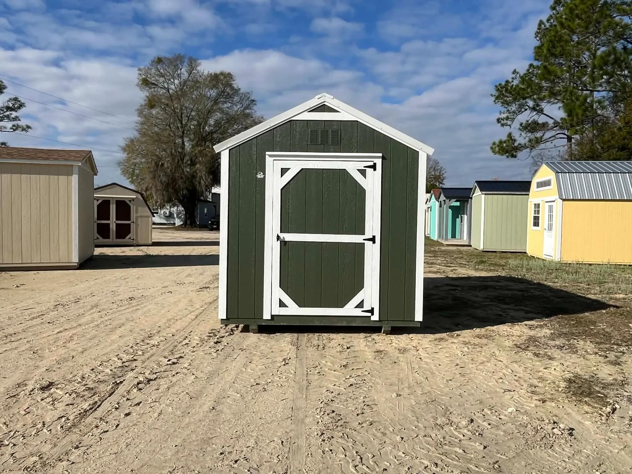 Exterior of a green 8x12 garden shed economy showing wood door