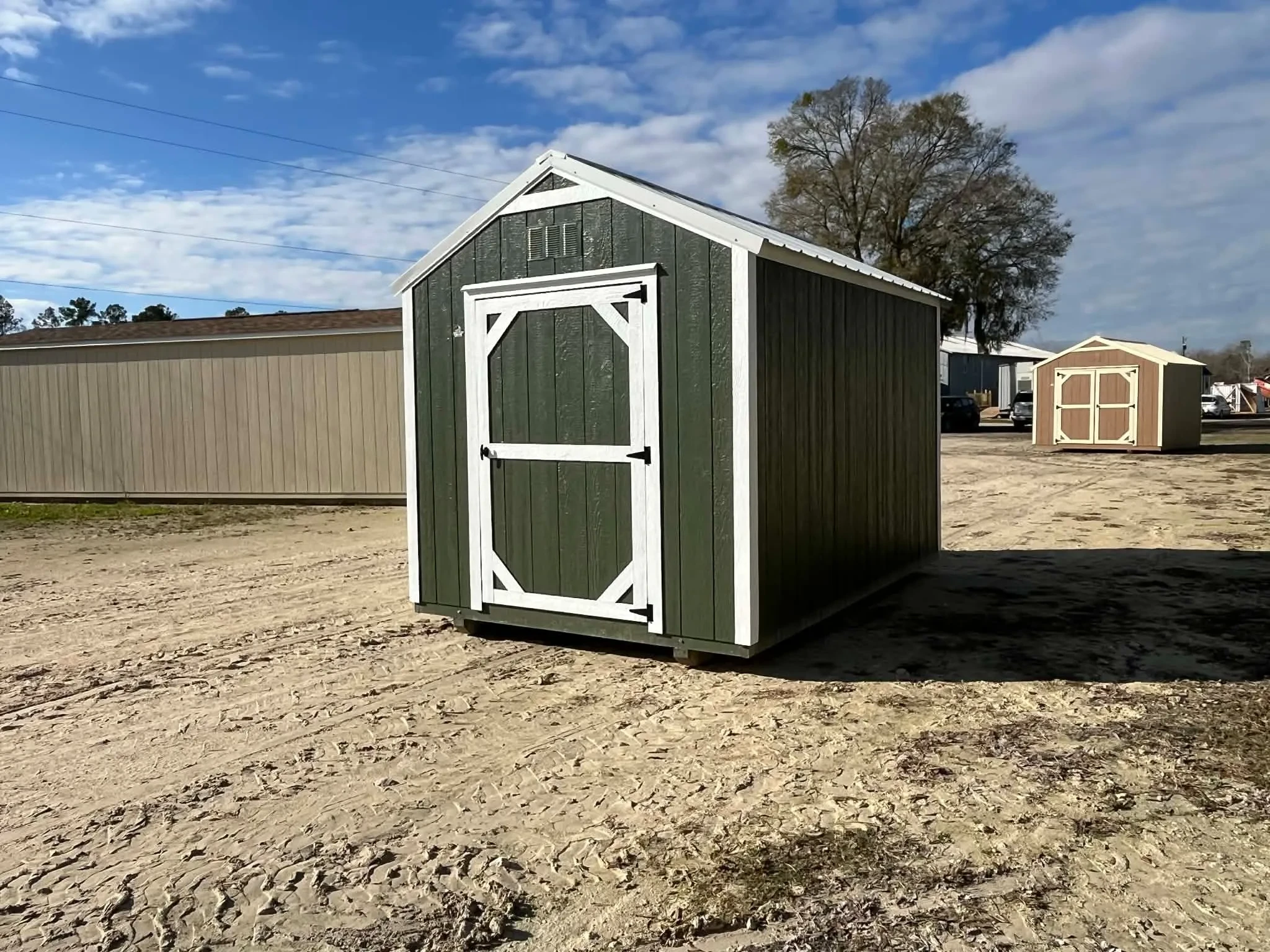 Exterior right side of a green 8x12 garden shed economy showing wood door