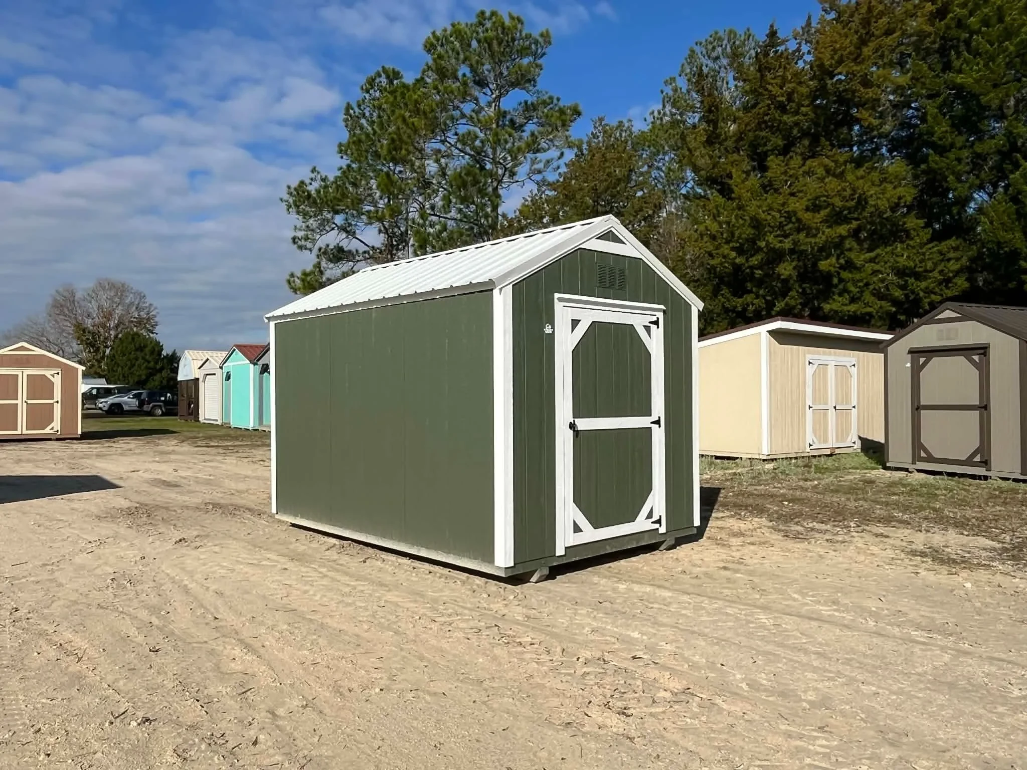 Exterior left side of a green 8x12 garden shed economy showing wood door