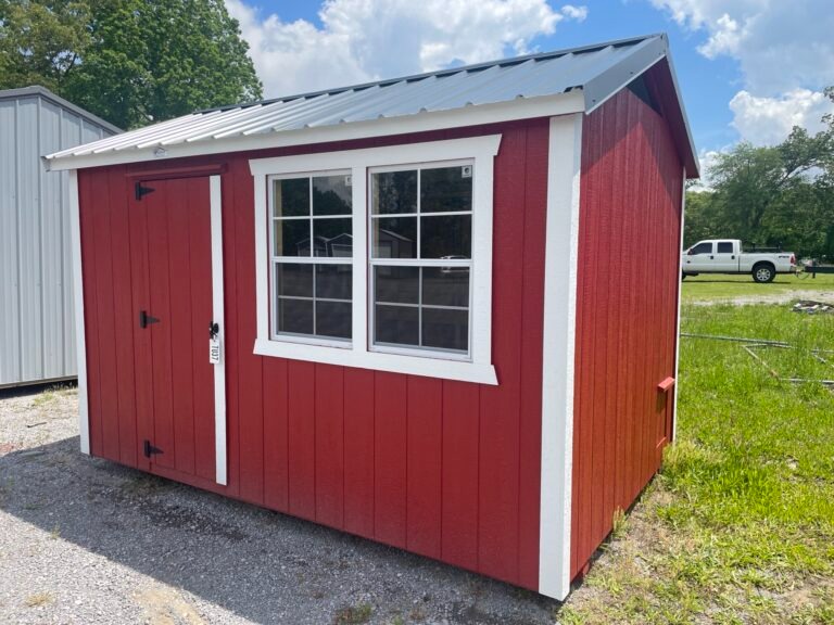 cute red and white chicken coop sitting on a shed sales lot
