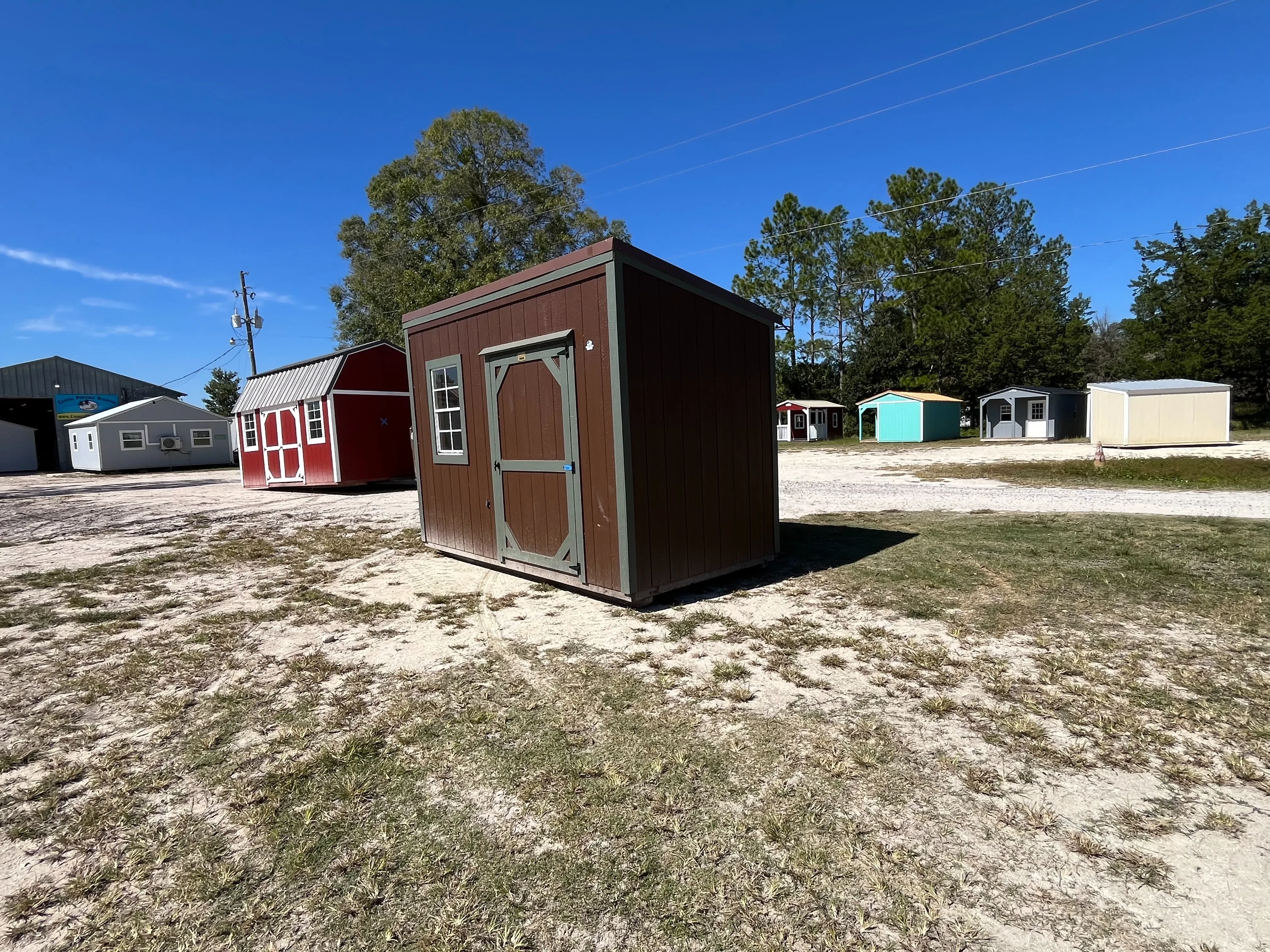 Exterior of a 6x12 brown urban with a wood door and window
