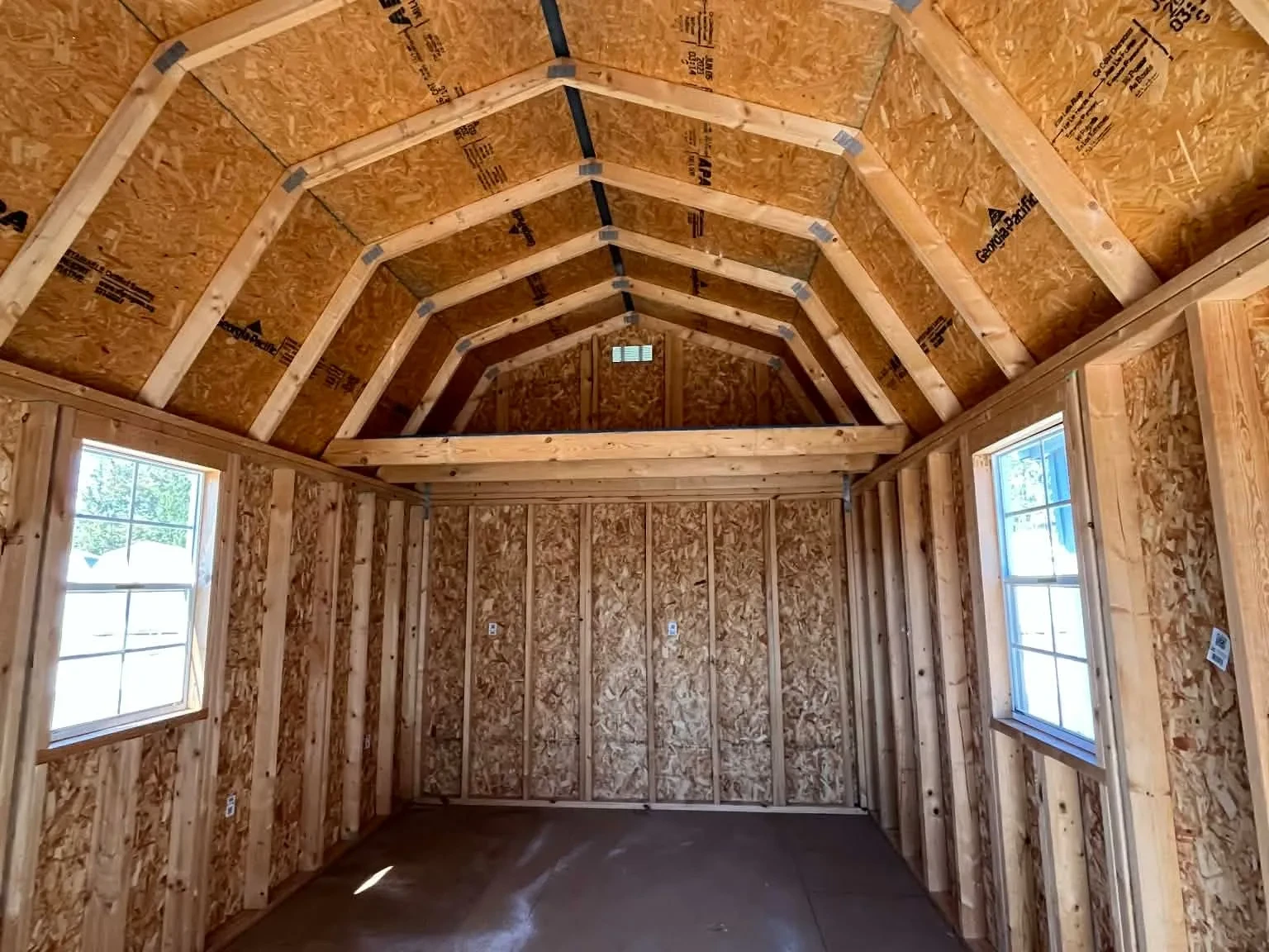 Interior of a 10x20 Lofted Barn Cabin showing the loft and windows
