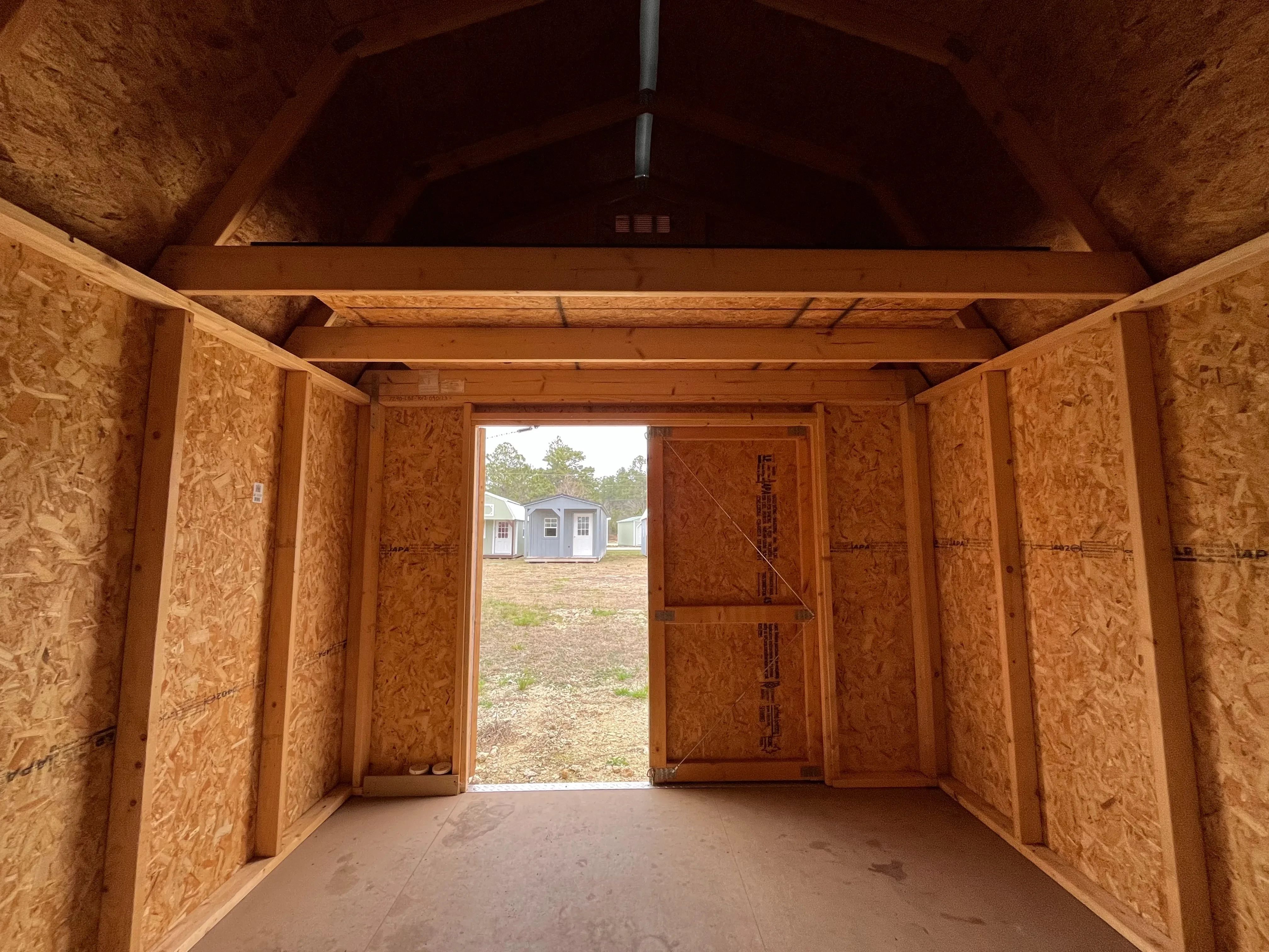 Interior of a 10x12 lofted barn economy showing the loft and doors