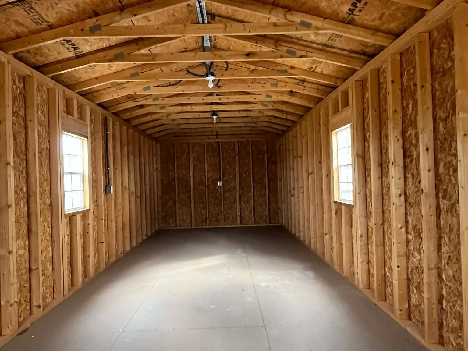 Interior of a 12x36 Cabin viewing through the entry door showing the windows and electric