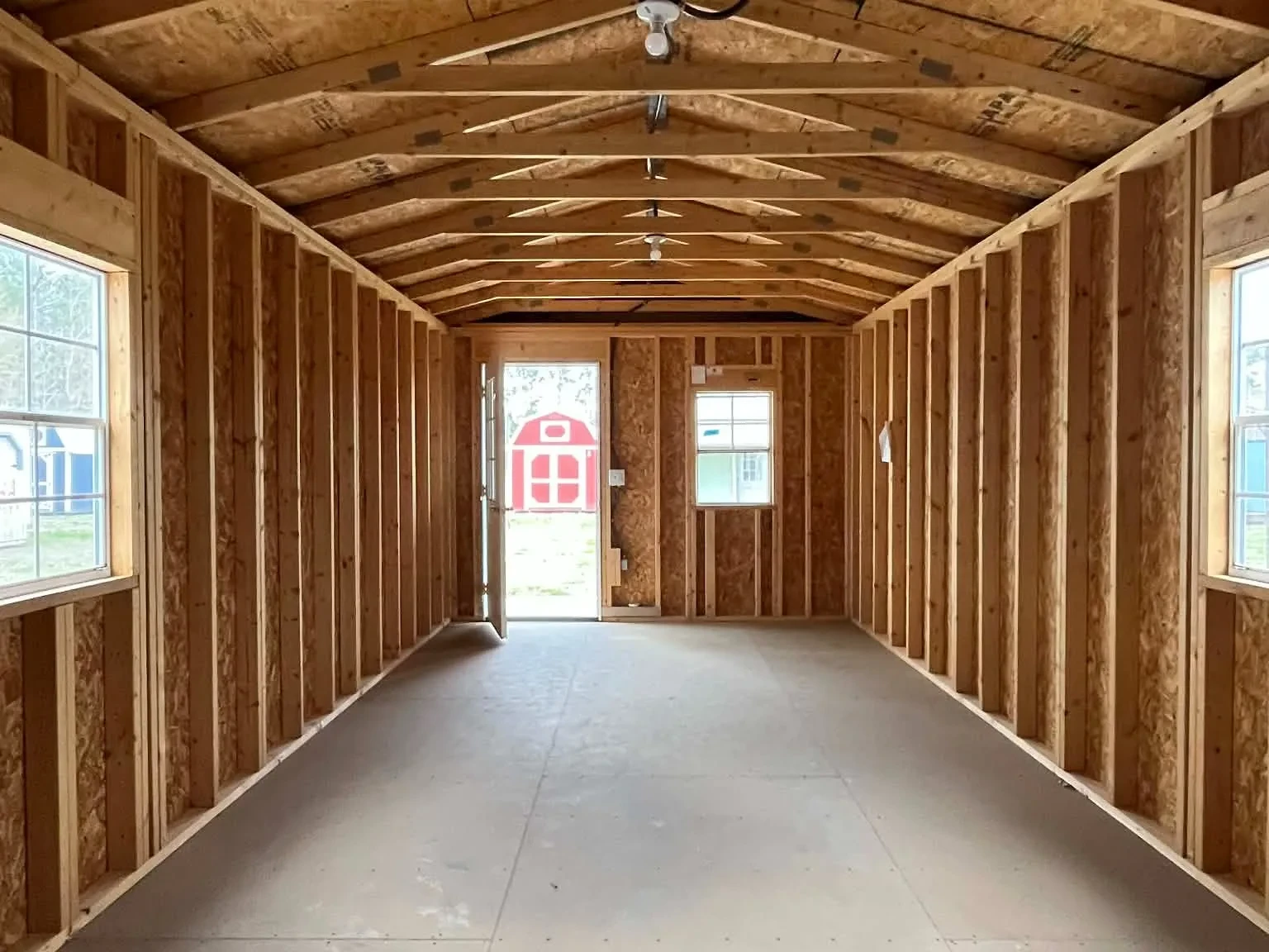 Interior of a 12x36 Cabin viewing from the back wall showing the entry door, windows and electric