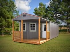 gray deluxe cabin with a light stain L-shaped wood porch