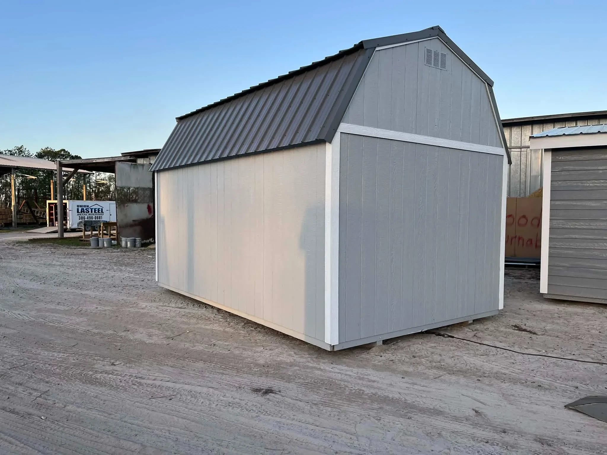 Exterior rear view of a grey 10x16 side lofted barn