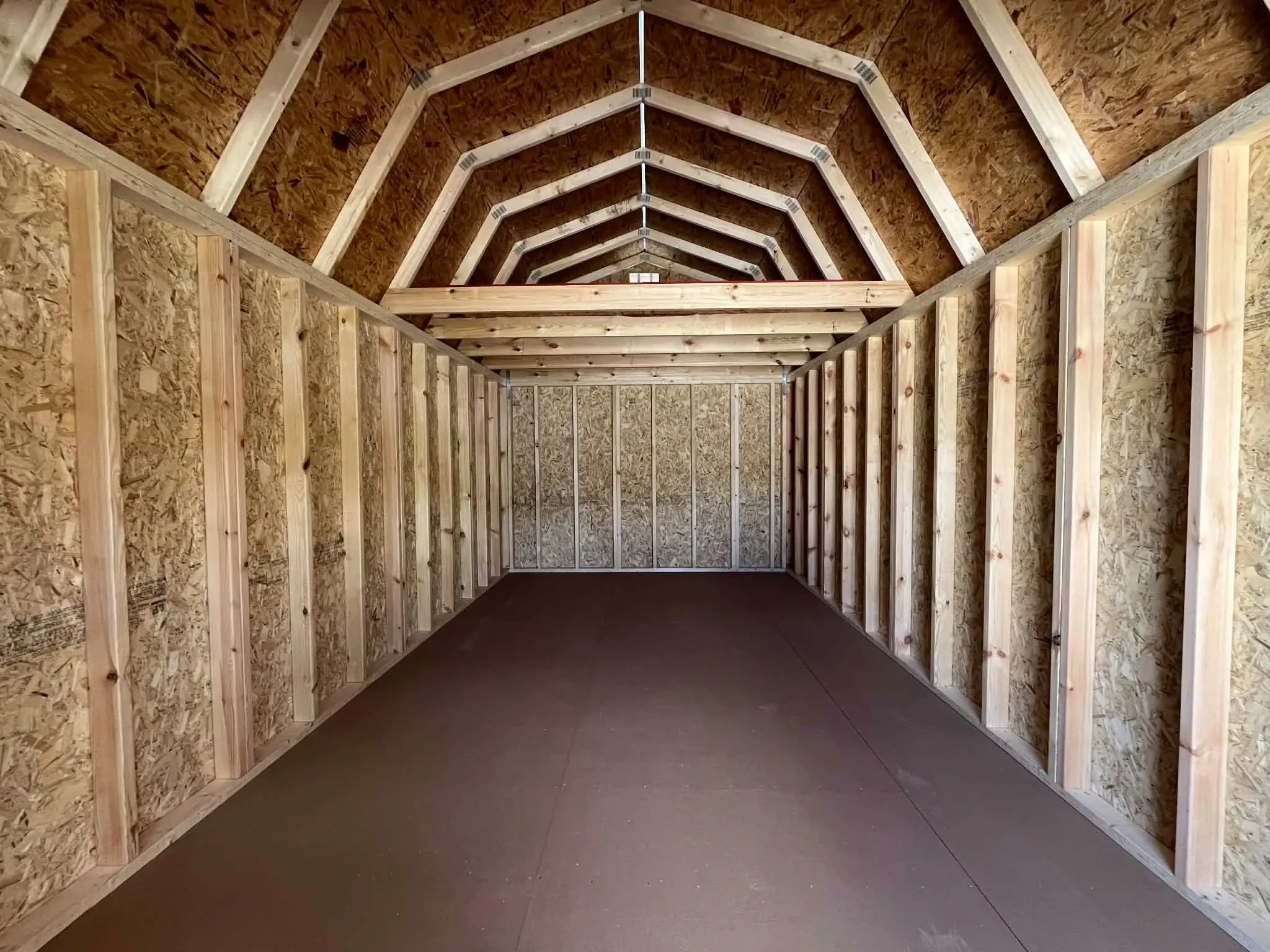 Interior of of a 10x20 lofted barn showing through the doors viewing the loft