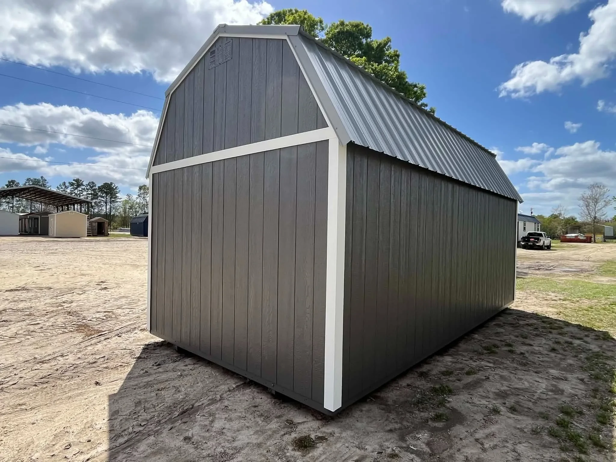 Exterior rear view of a dark grey 10x20 side lofted barn