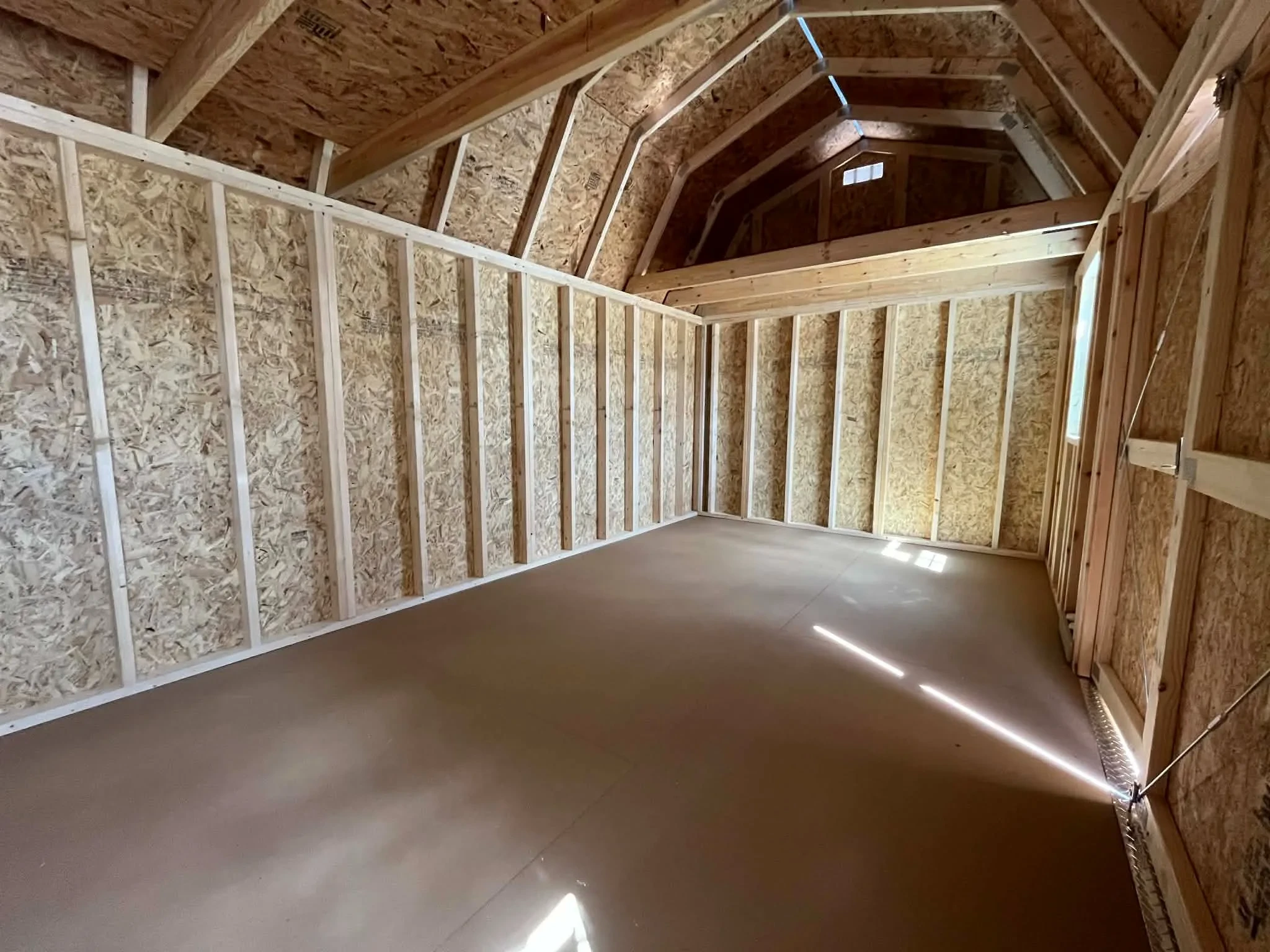 Interior of a 10x20 side lofted barn showing the loft area