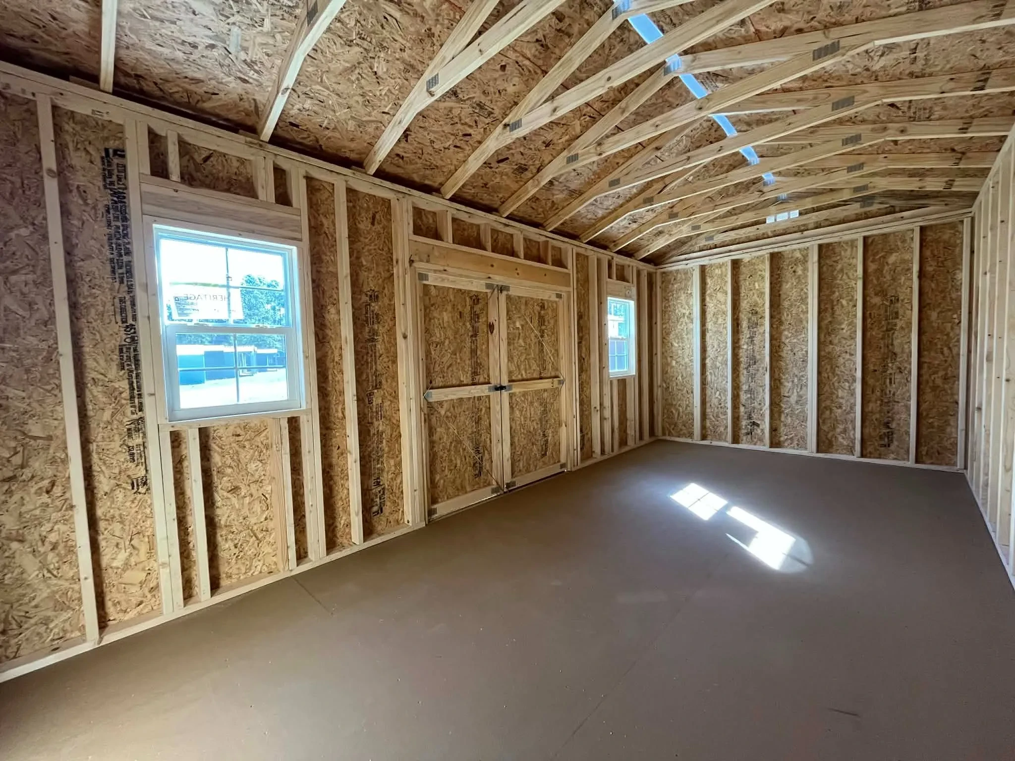 Interior view of a 10x20 side garden shed showing the window and doors