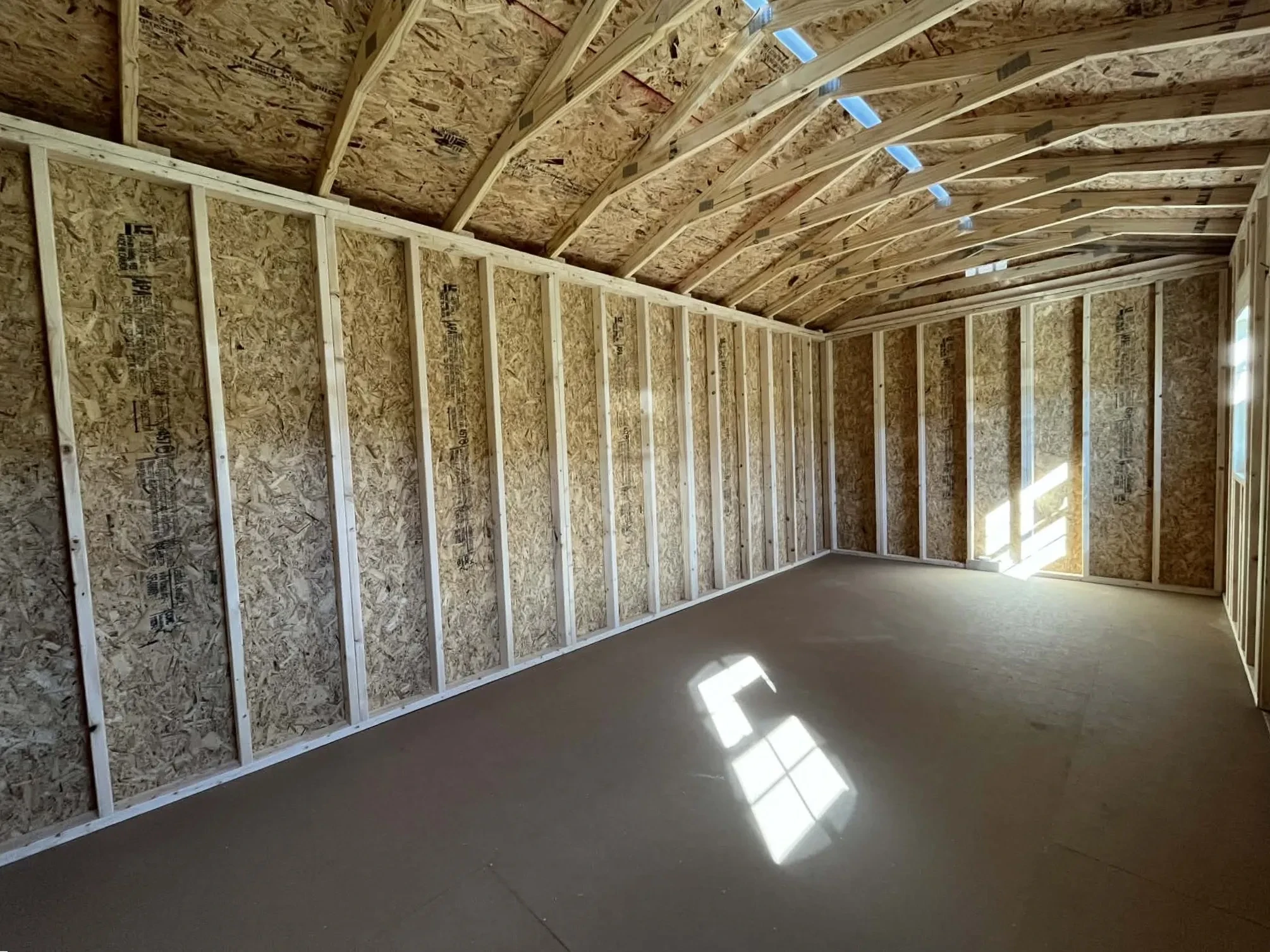 Interior view of a 10x20 side garden shed showing back wall and storage space