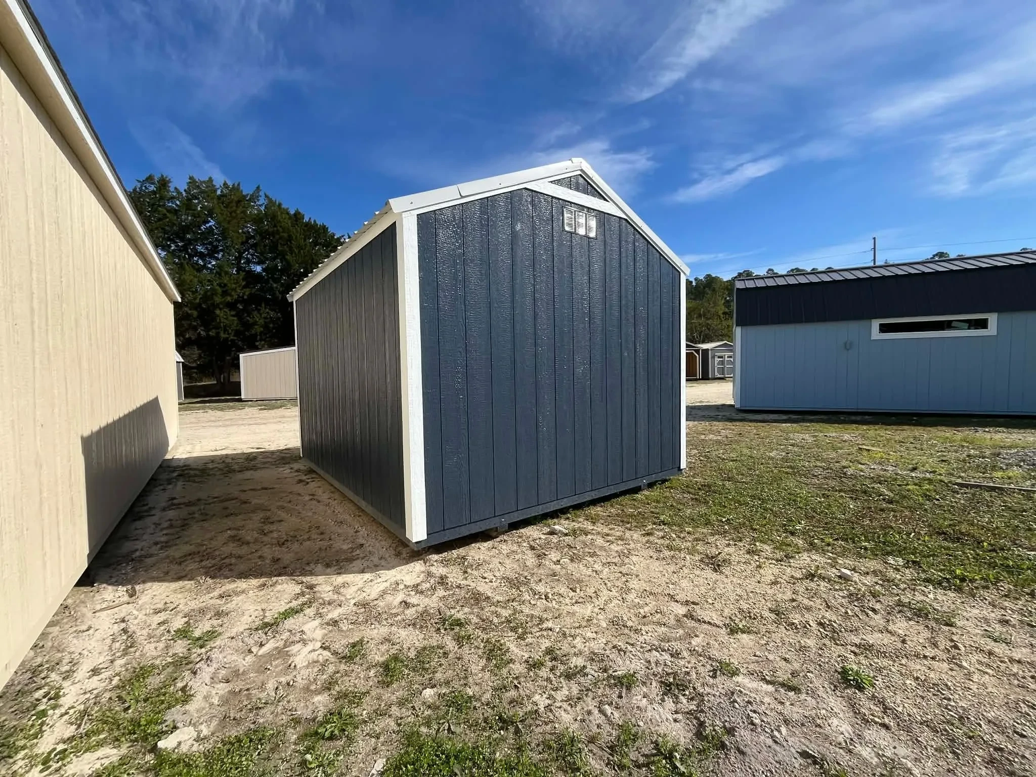 Exterior rear view of a 10x12 dark blue garden shed economy