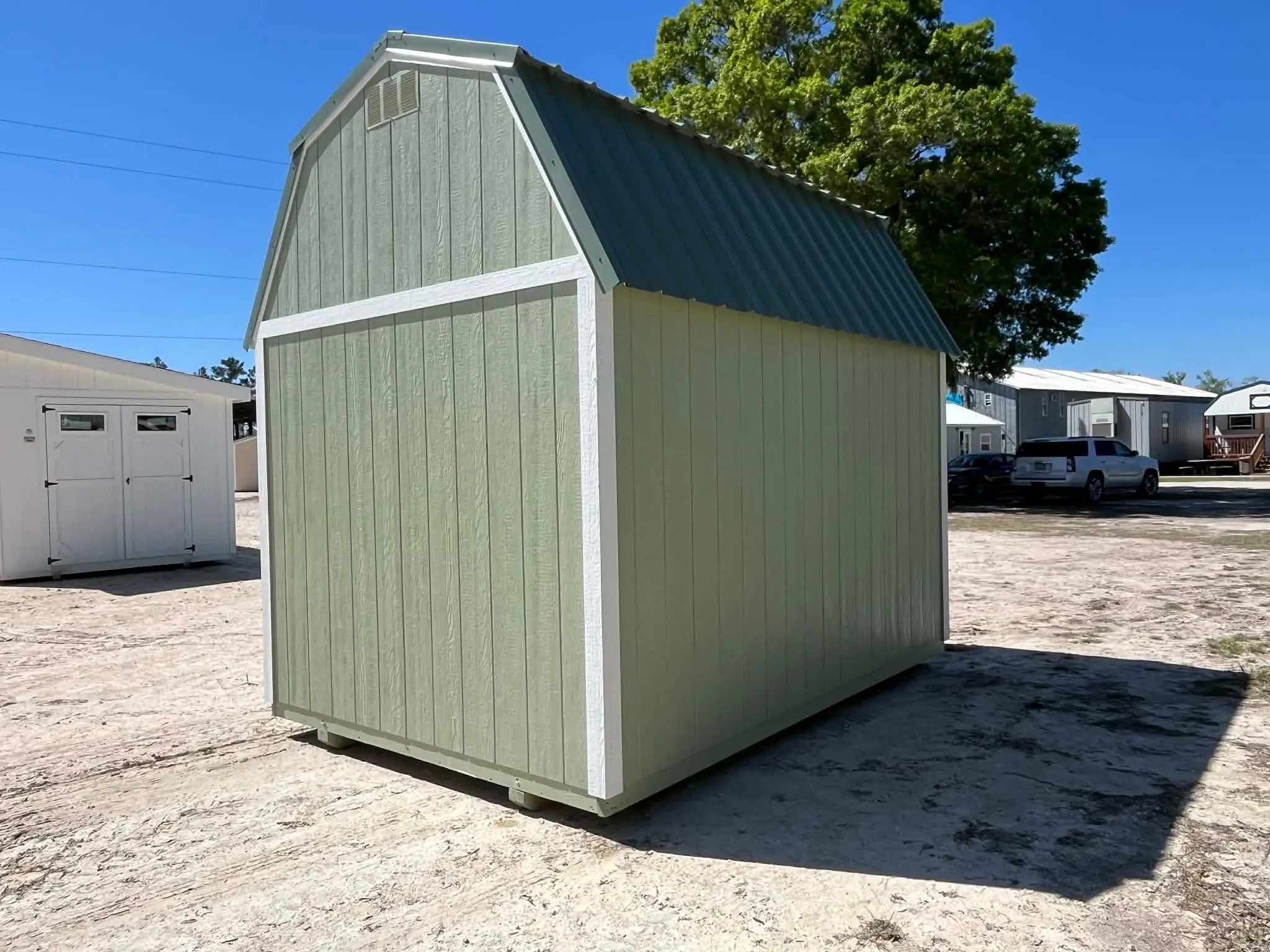 Exterior rear view of a green 8x12 side lofted barn