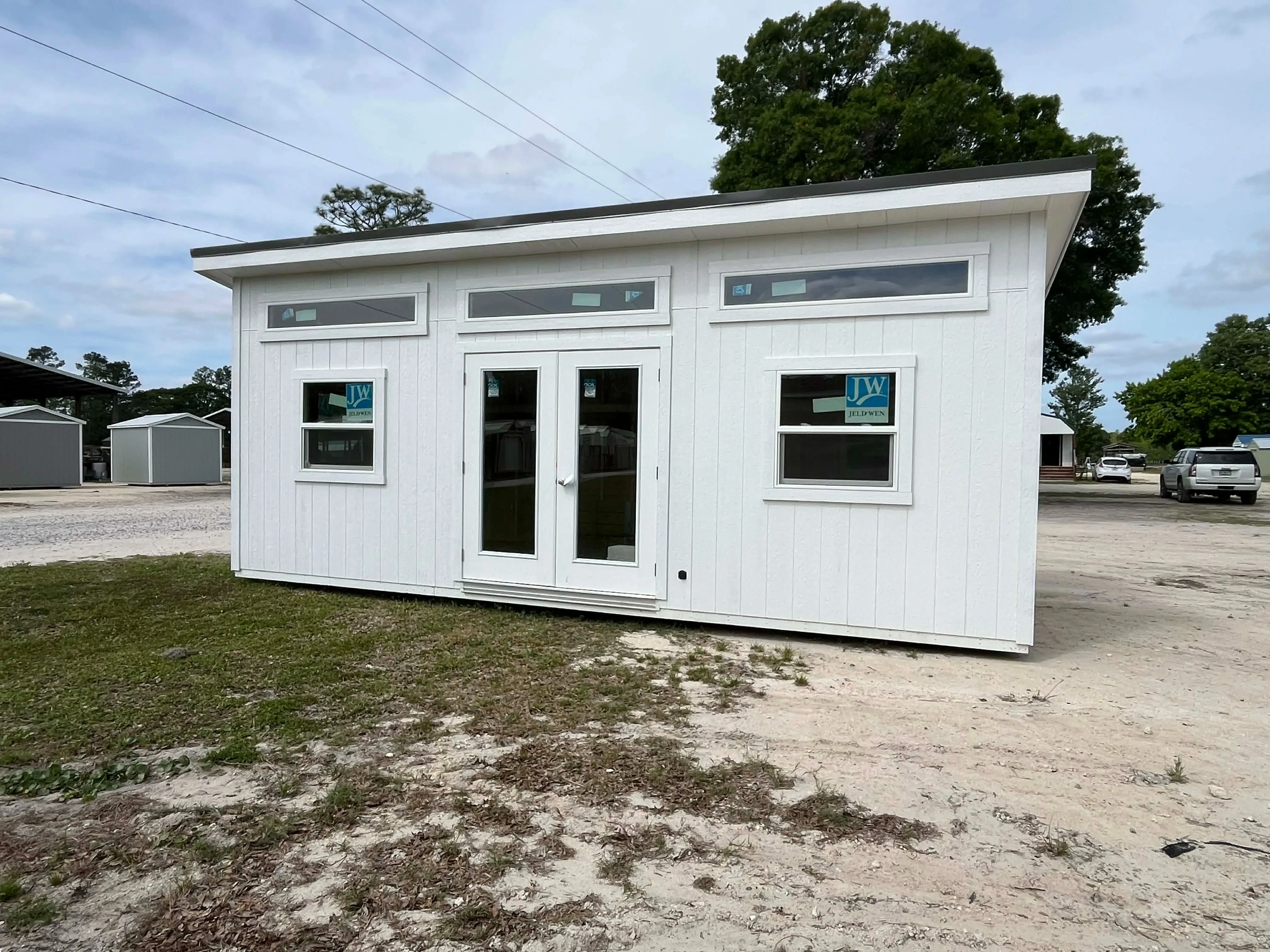 Exterior front view of a white 10x24 urban showing the french doors and windows
