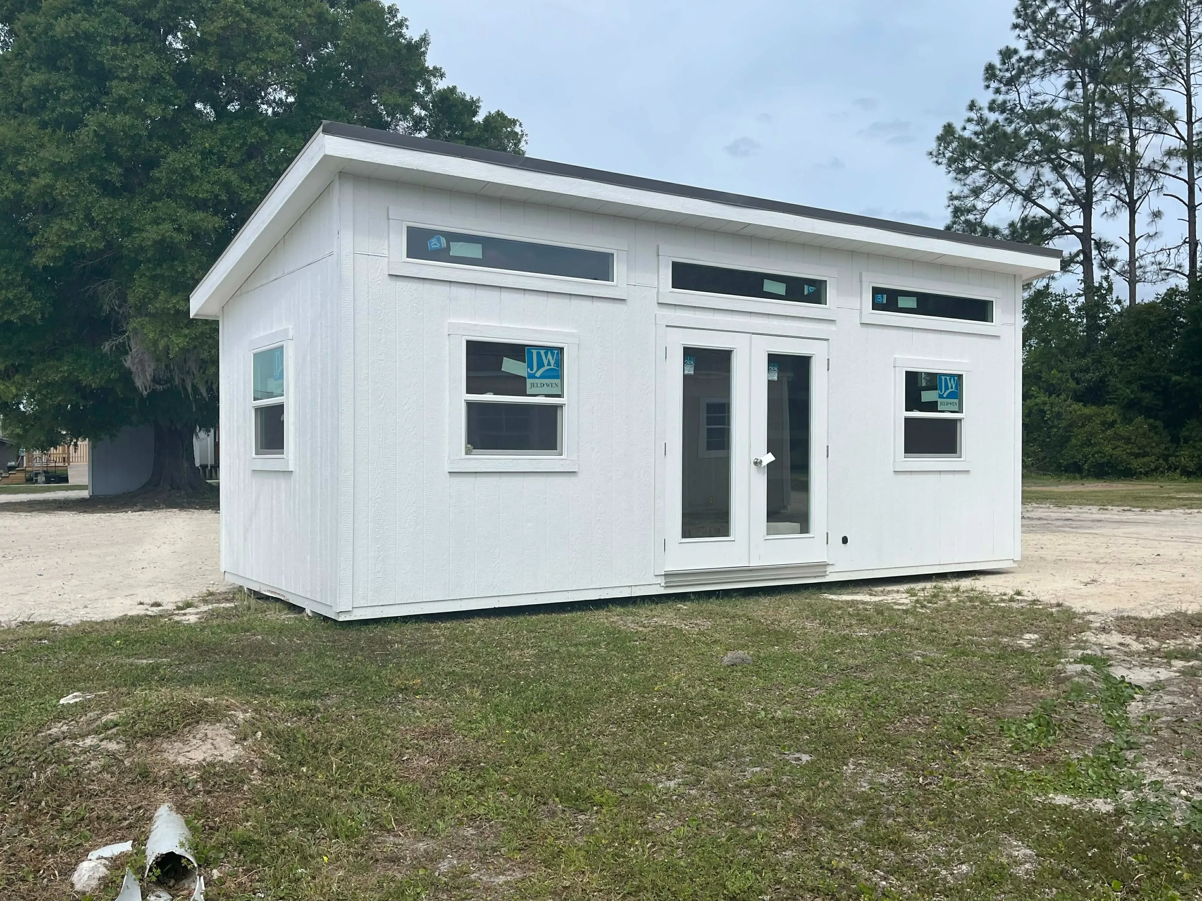 Exterior front view of a white 10x24 urban showing the french doors and windows