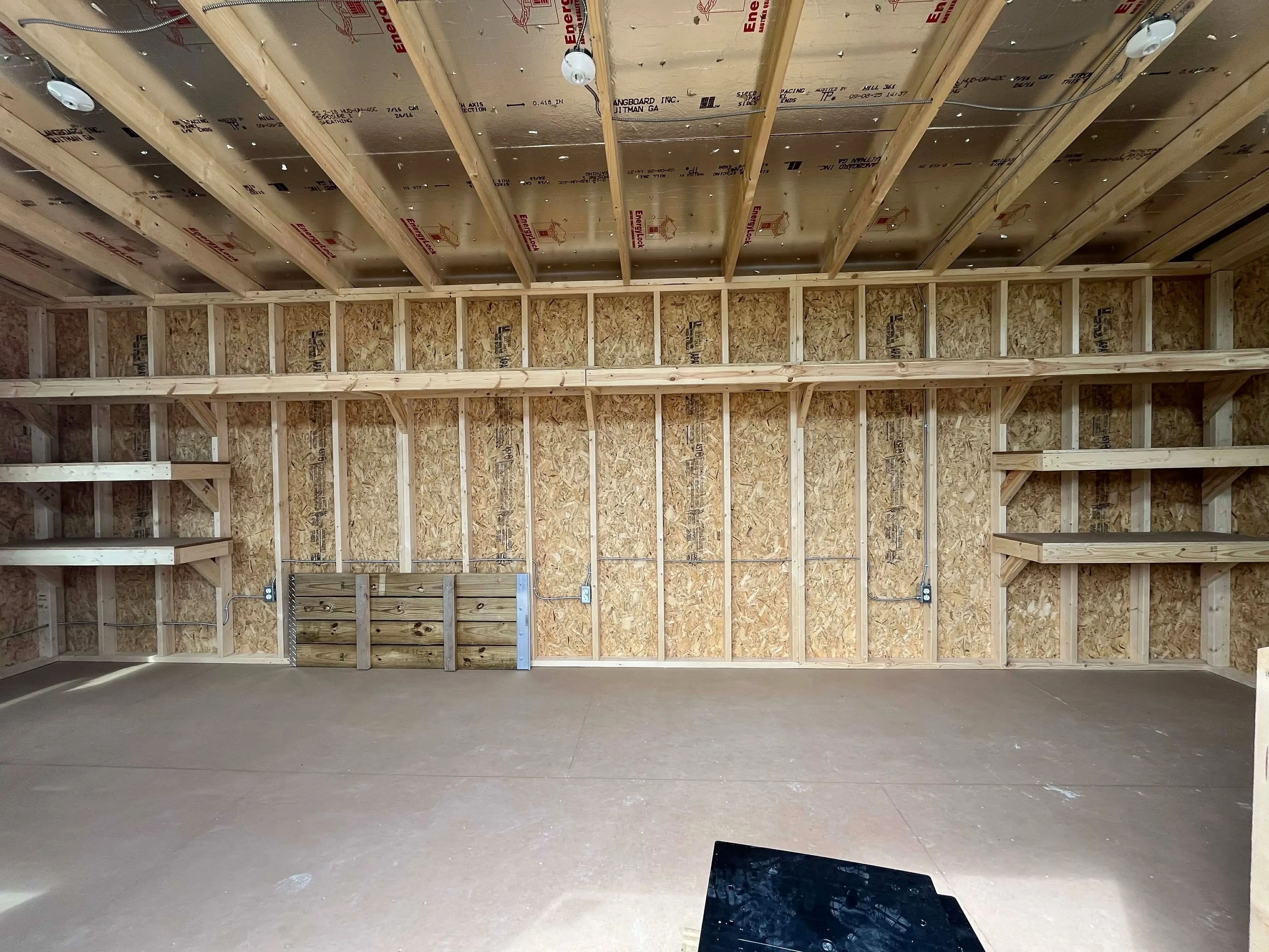 Interior view from doors showing back wall and shelving.