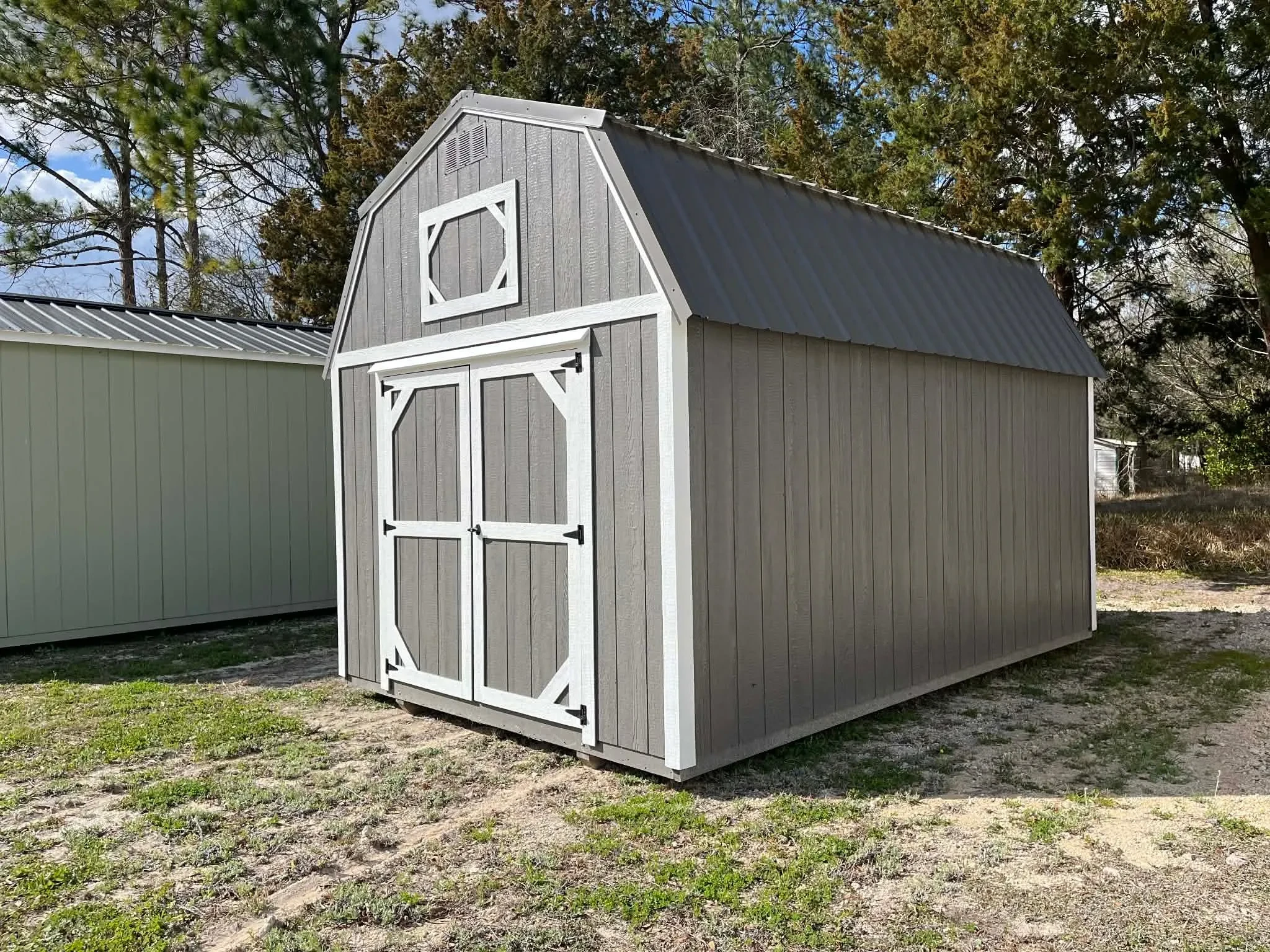 Exterior Right front view of a dark grey 10x16 lofted barn showing the double wood doors