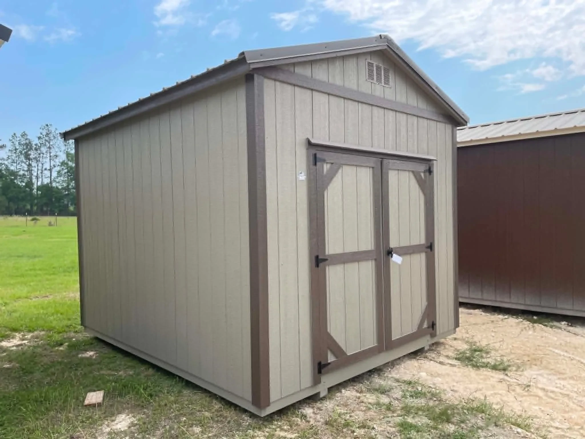 Exterior front left view of a 10x12 garden shed with double wood doors