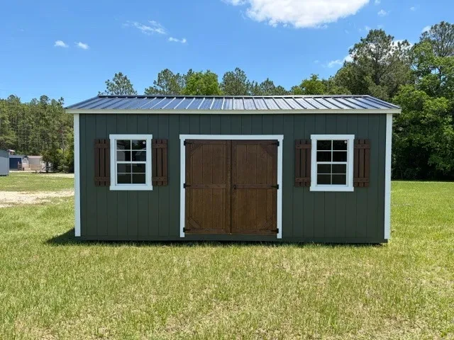Exterior front view of a green 10x20 side garden shed showing the doors, windows and shutters