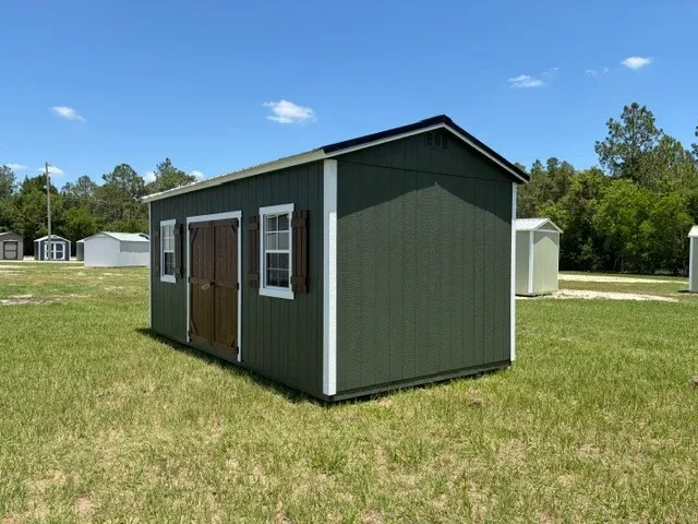Exterior front right view of a green 10x20 side garden shed showing the doors, windows and shutters