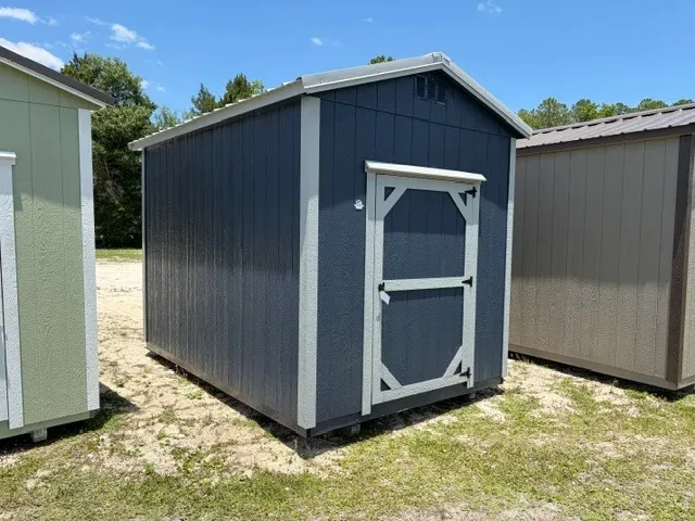 Exterior front left view of dark blue 8x12 garden shed with a wood door