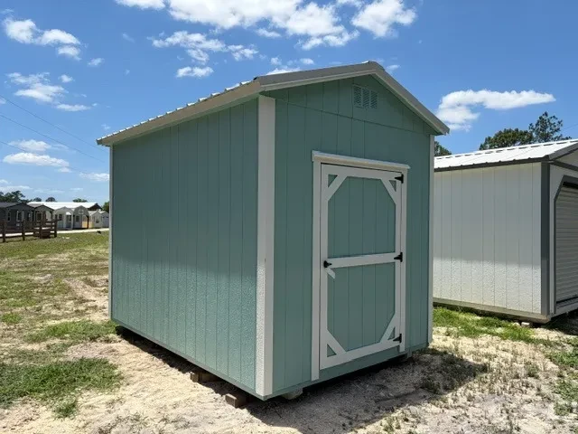 Exterior front left view of a aqua 8x12 garden shed showing the wood door