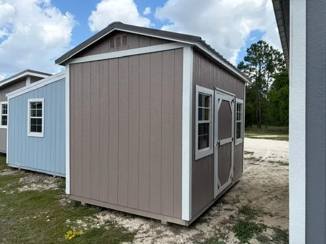 Outside view of an 8x12 Side Garden Shed with single wood door, two windows, painted wood side and metal roof