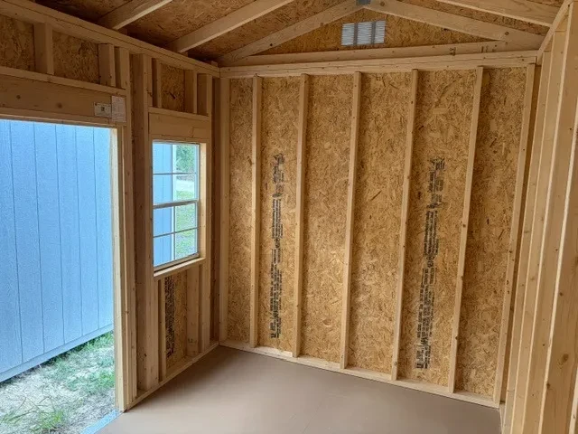 Interior of an 8x12 side garden shed showing open door and one window