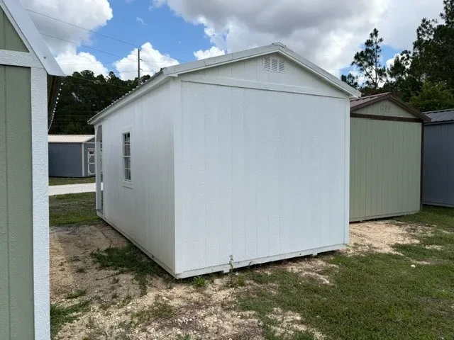 Back view of a 10x20 cabin with white painted siding and white roof