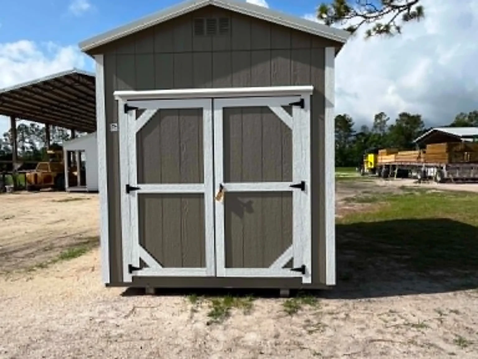 Exterior front view of a clay color 8x12 garden shed with doors