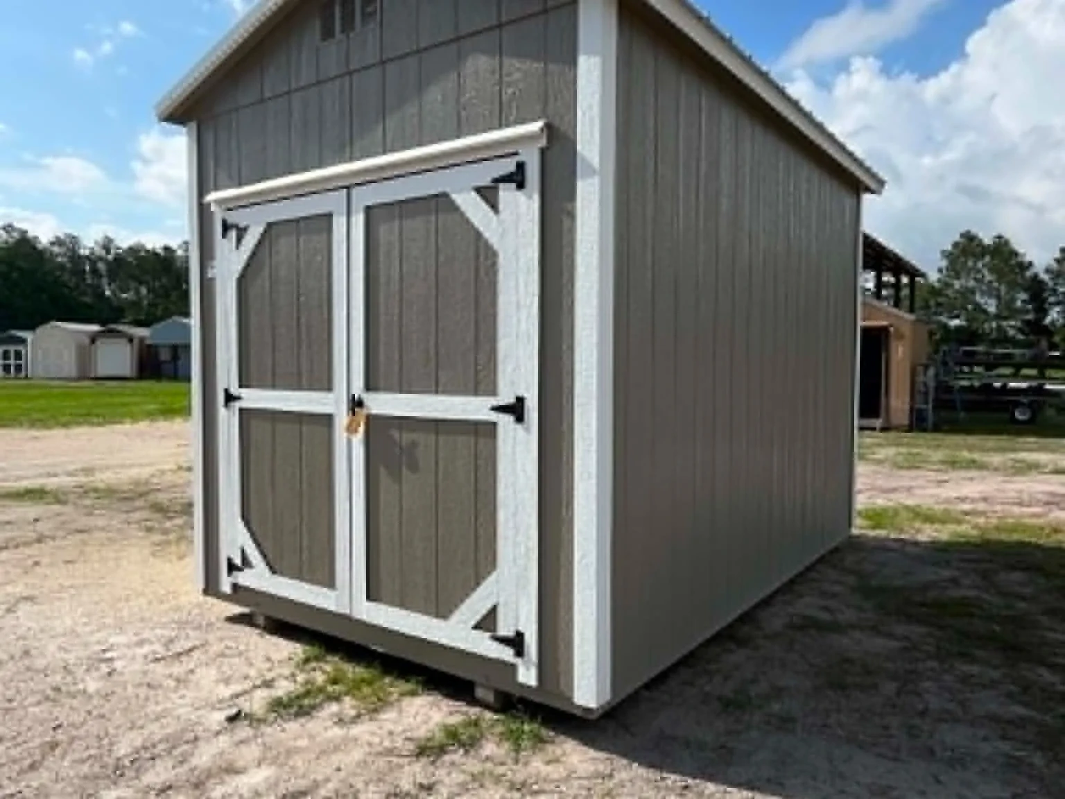 Exterior front right view of a clay color 8x12 garden shed with doors