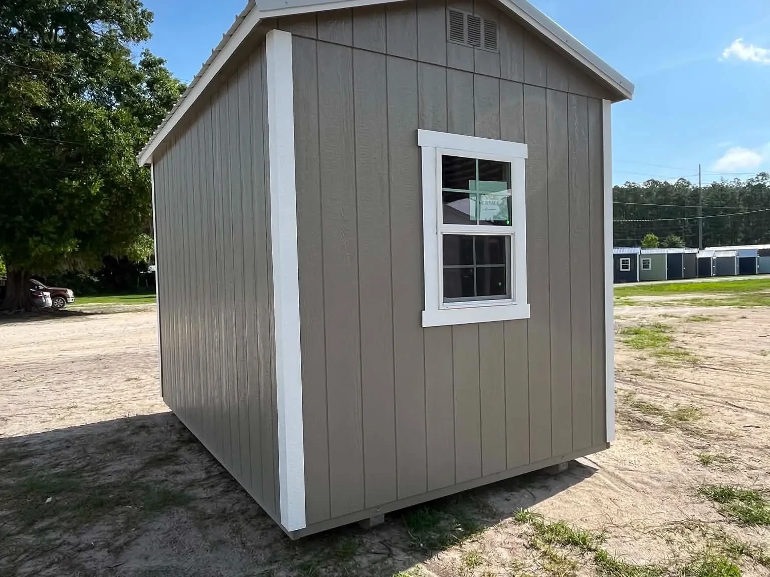 Exterior right rear view of a clay in color 8x12 garden shed showing a window