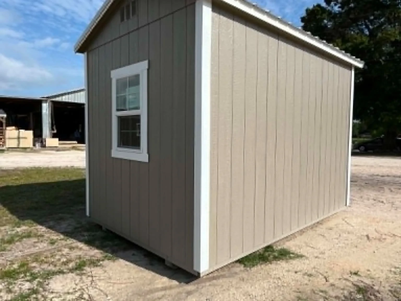 Exterior left rear view of a clay in color 8x12 garden shed showing a window