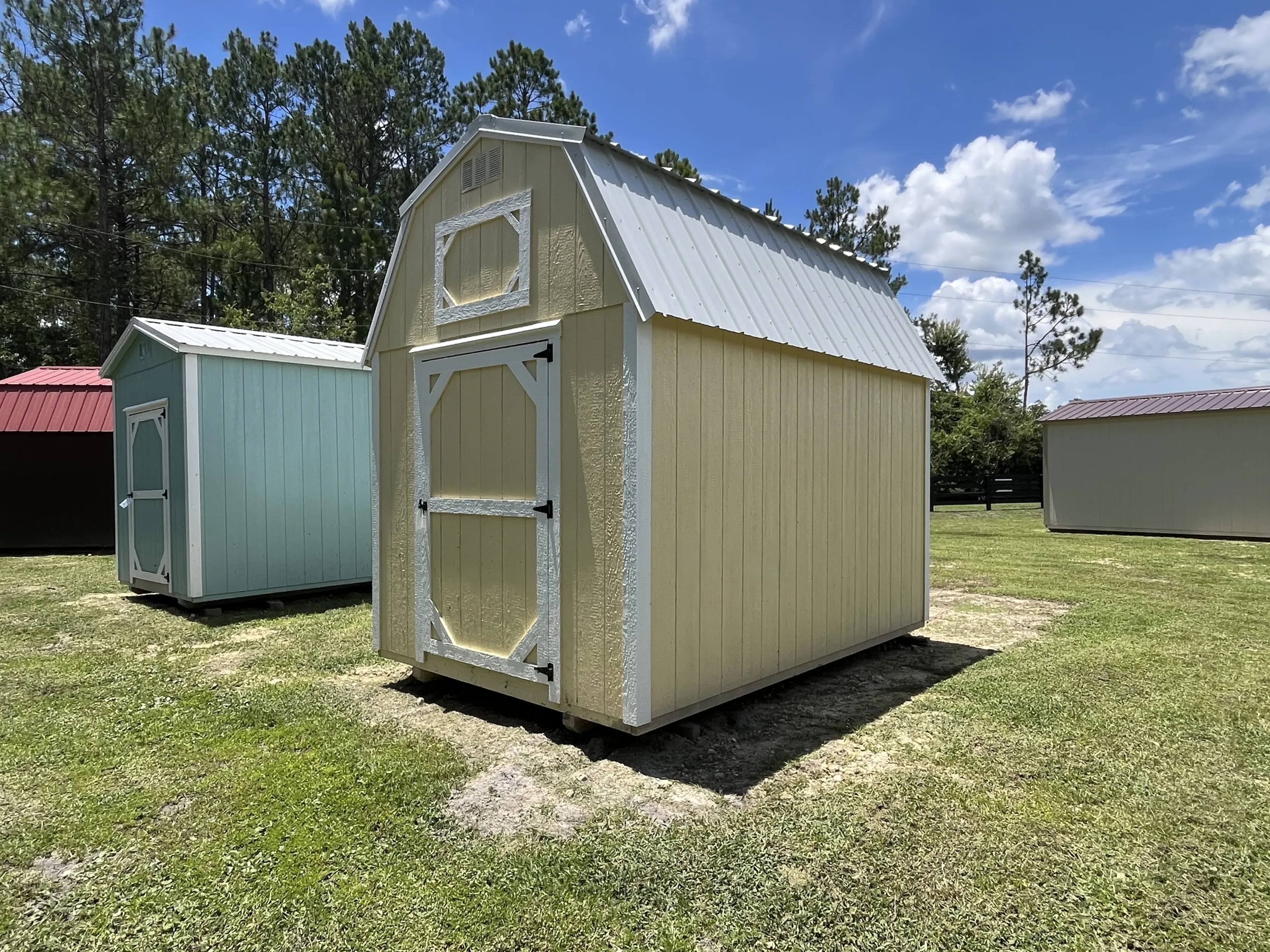 Exterior Front right view of an 8x12 yellow lofted Barn showing the door