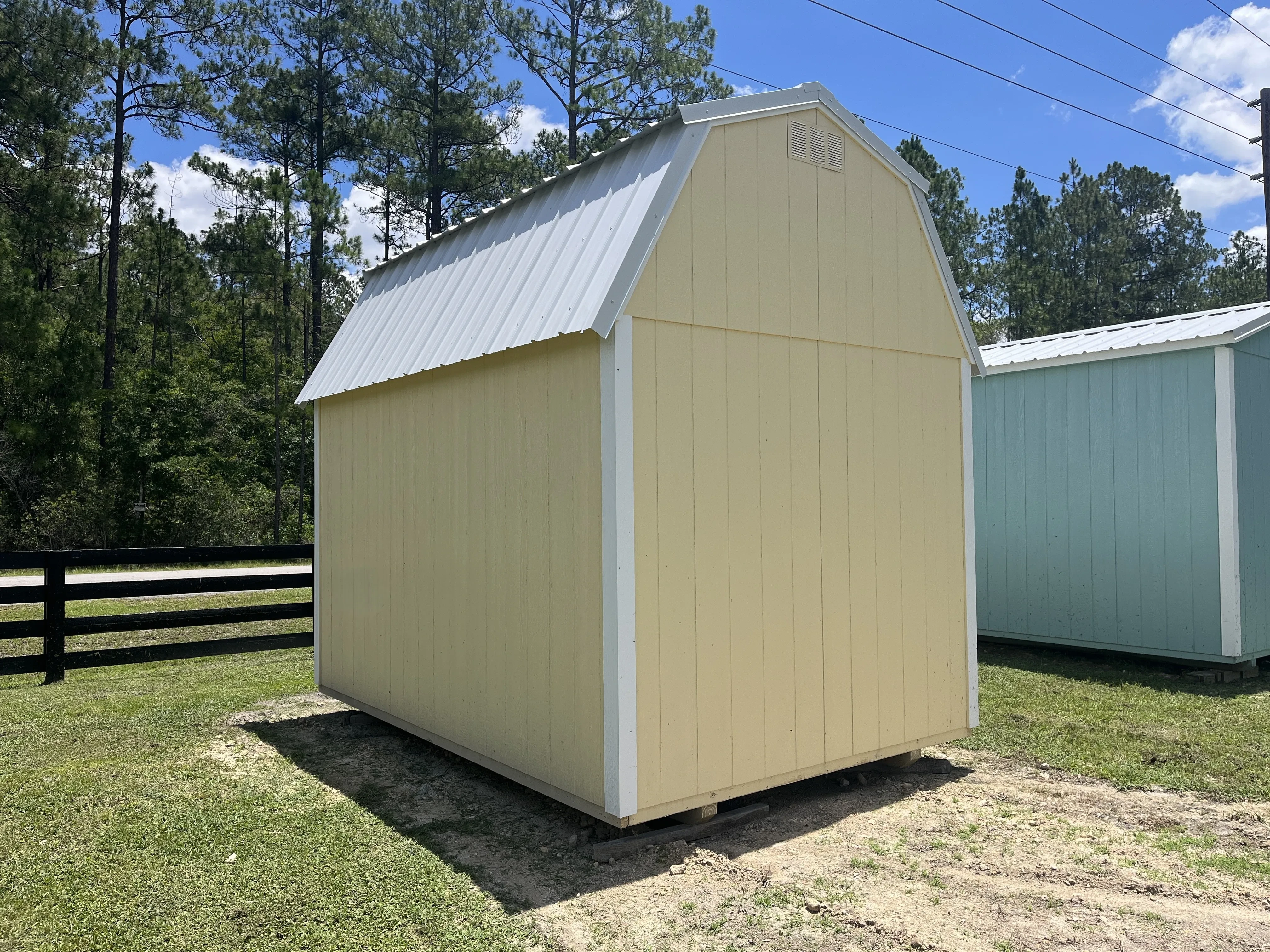 Exterior rear view of an 8x12 yellow lofted barn