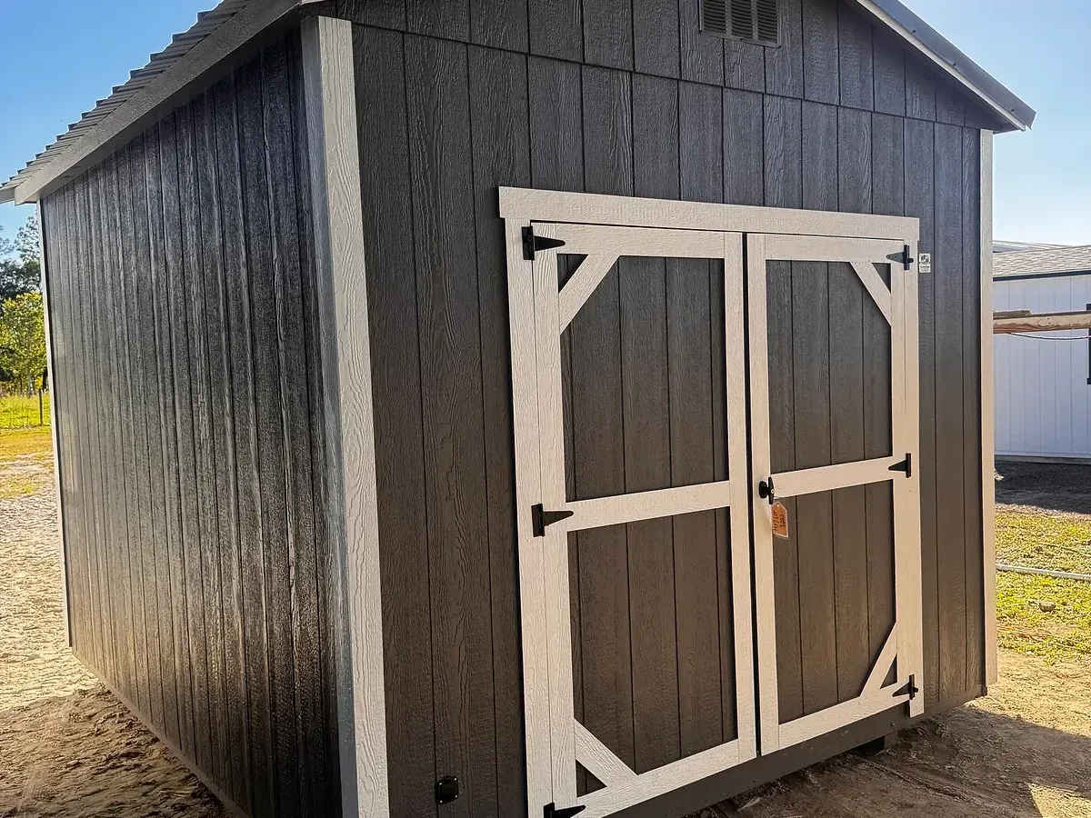 Exterior front view of a charcoal 10x12 garden shed with double wood door