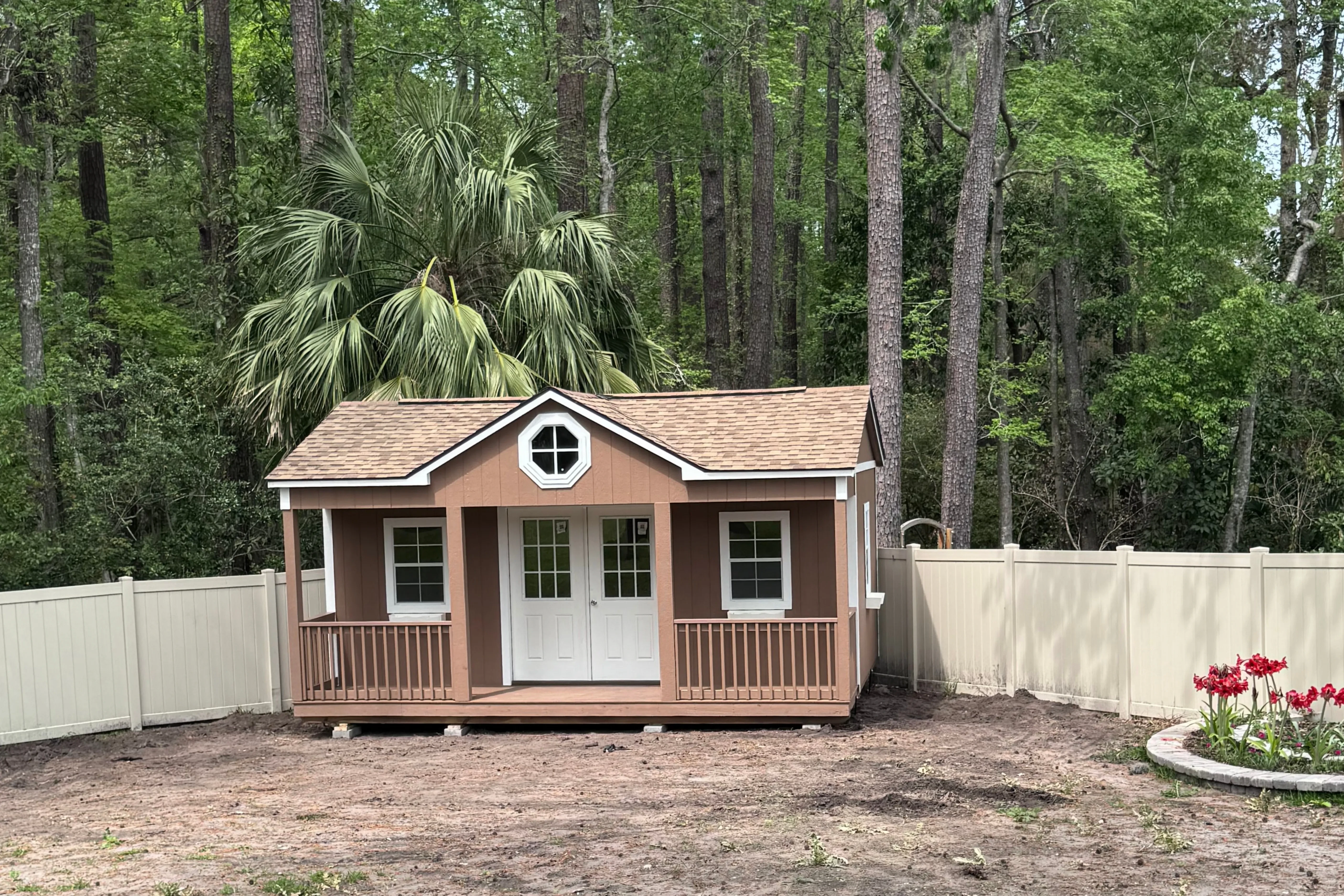 Cute playhouse shed by a fence